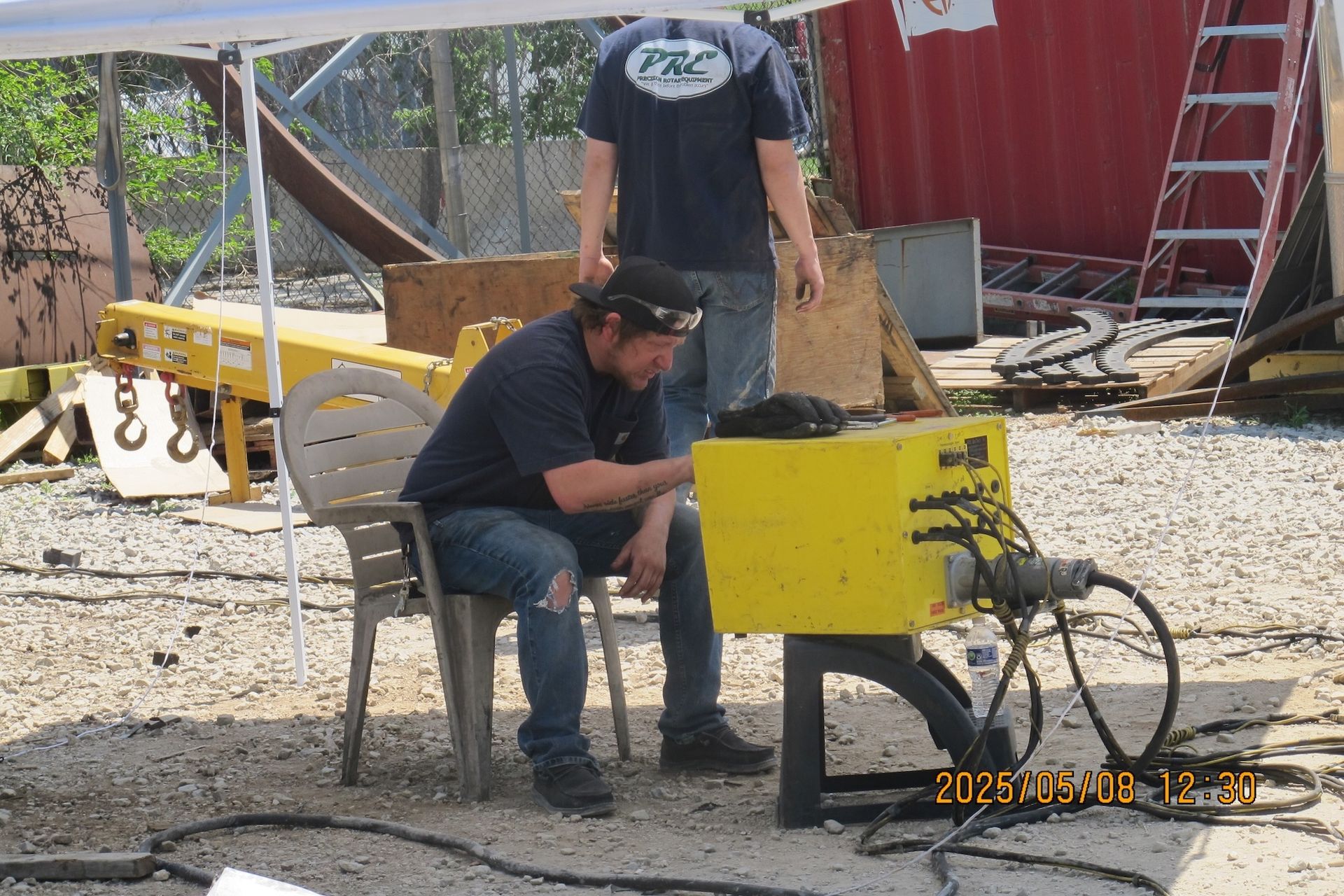 A man sitting in a chair looking at a yellow box