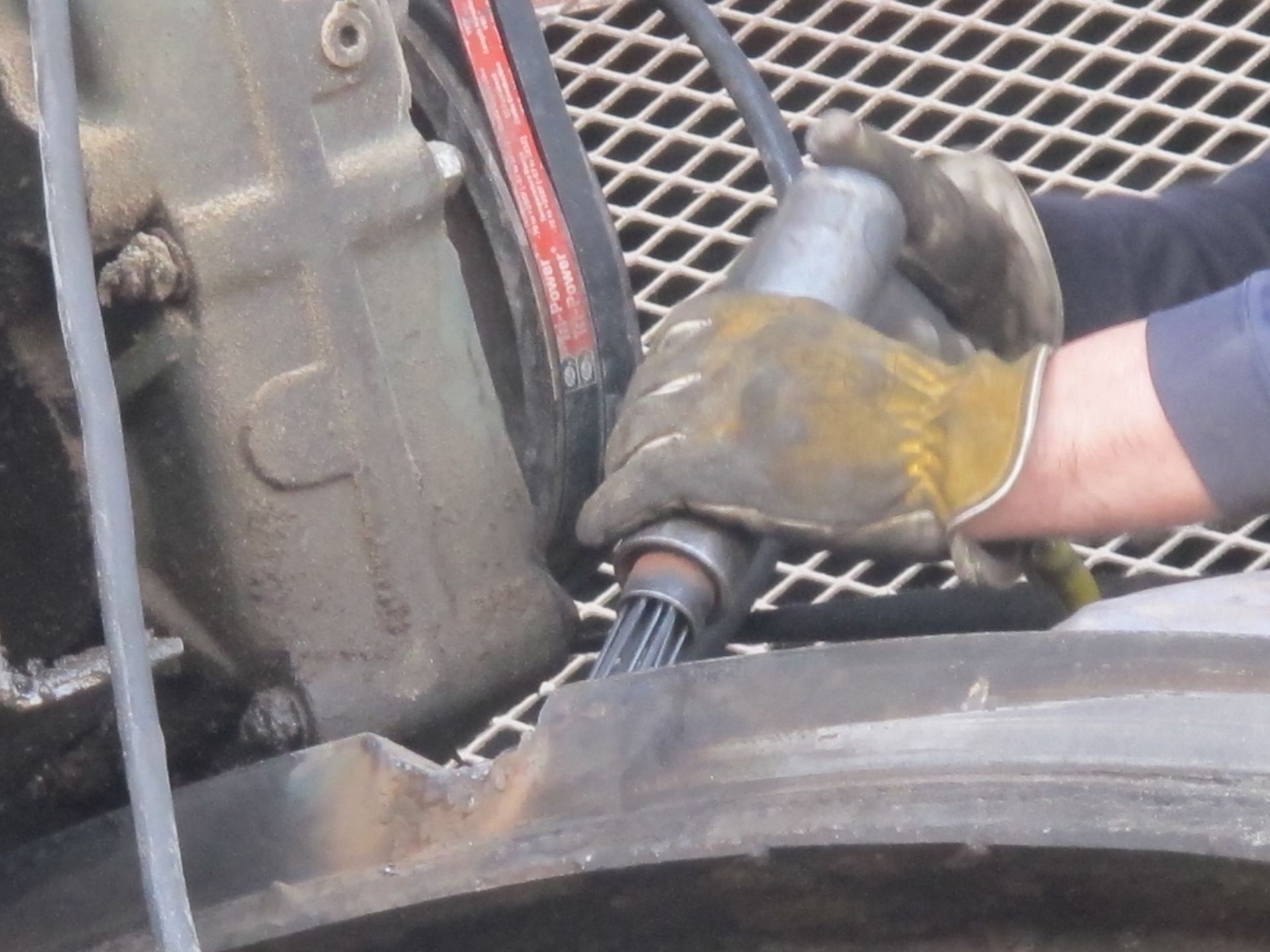 A person wearing gloves is working on a tire