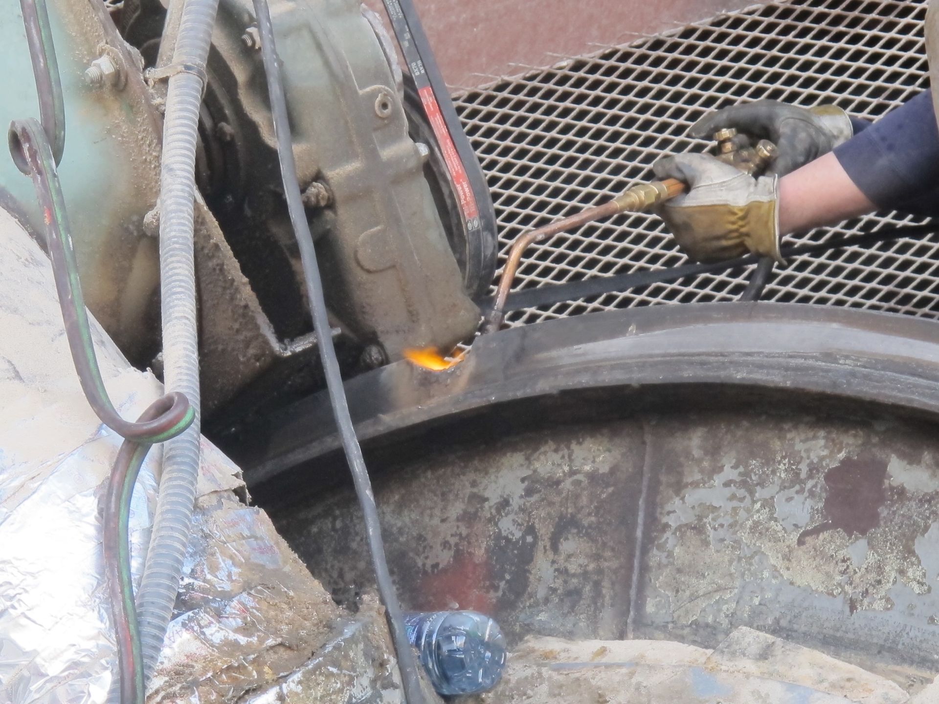 A person is cutting a piece of metal with a torch