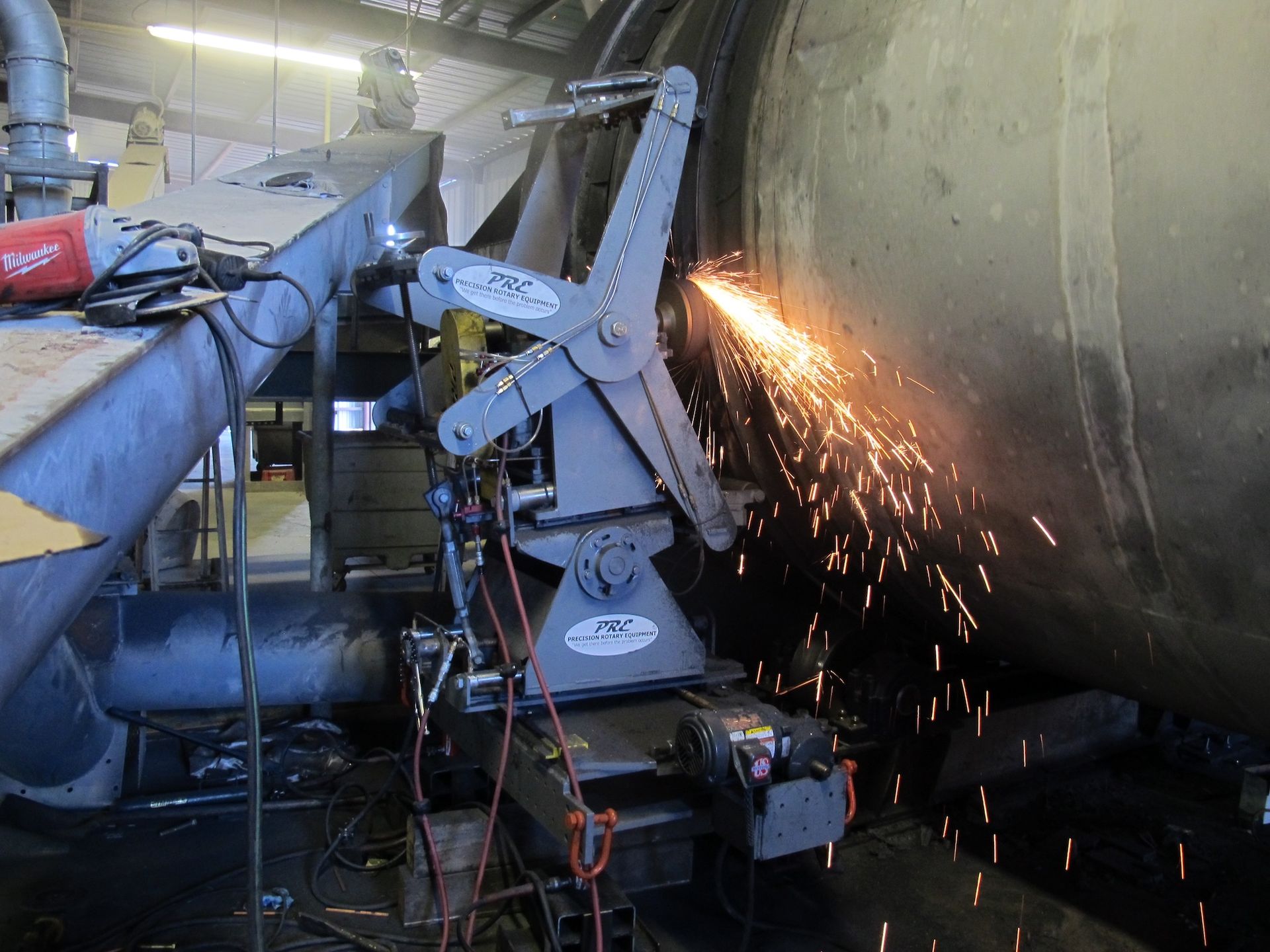A machine is cutting a pipe with sparks coming out of it