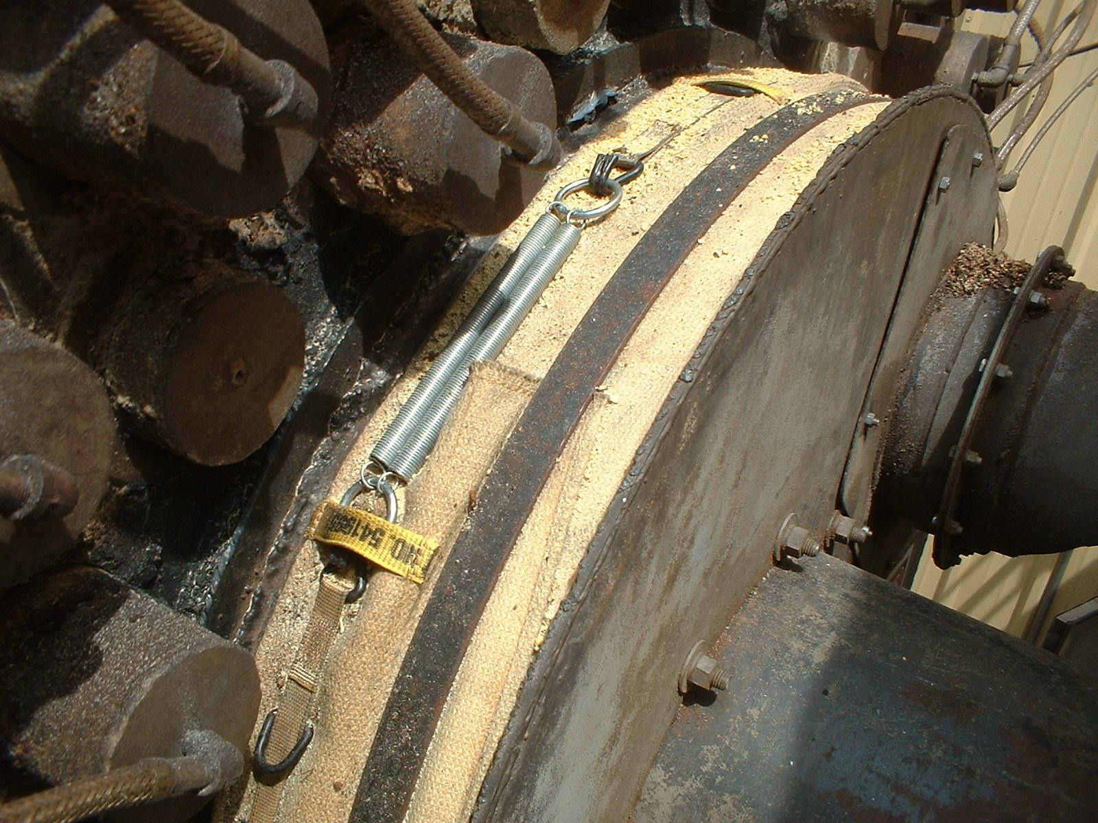 A piece of metal with a yellow tag on it