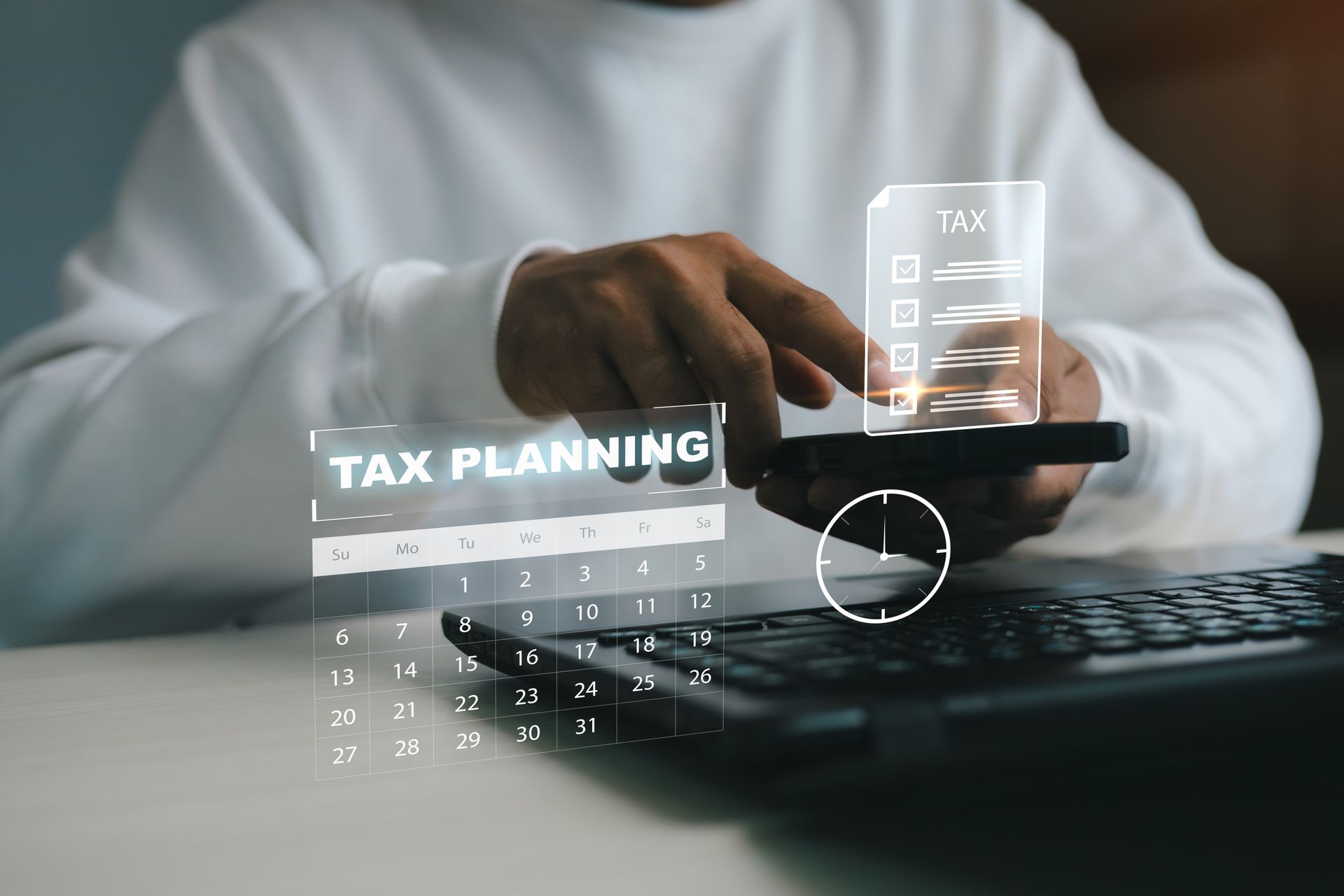 Hand using calculator beside laptop with “Tax Planning” overlay on screen