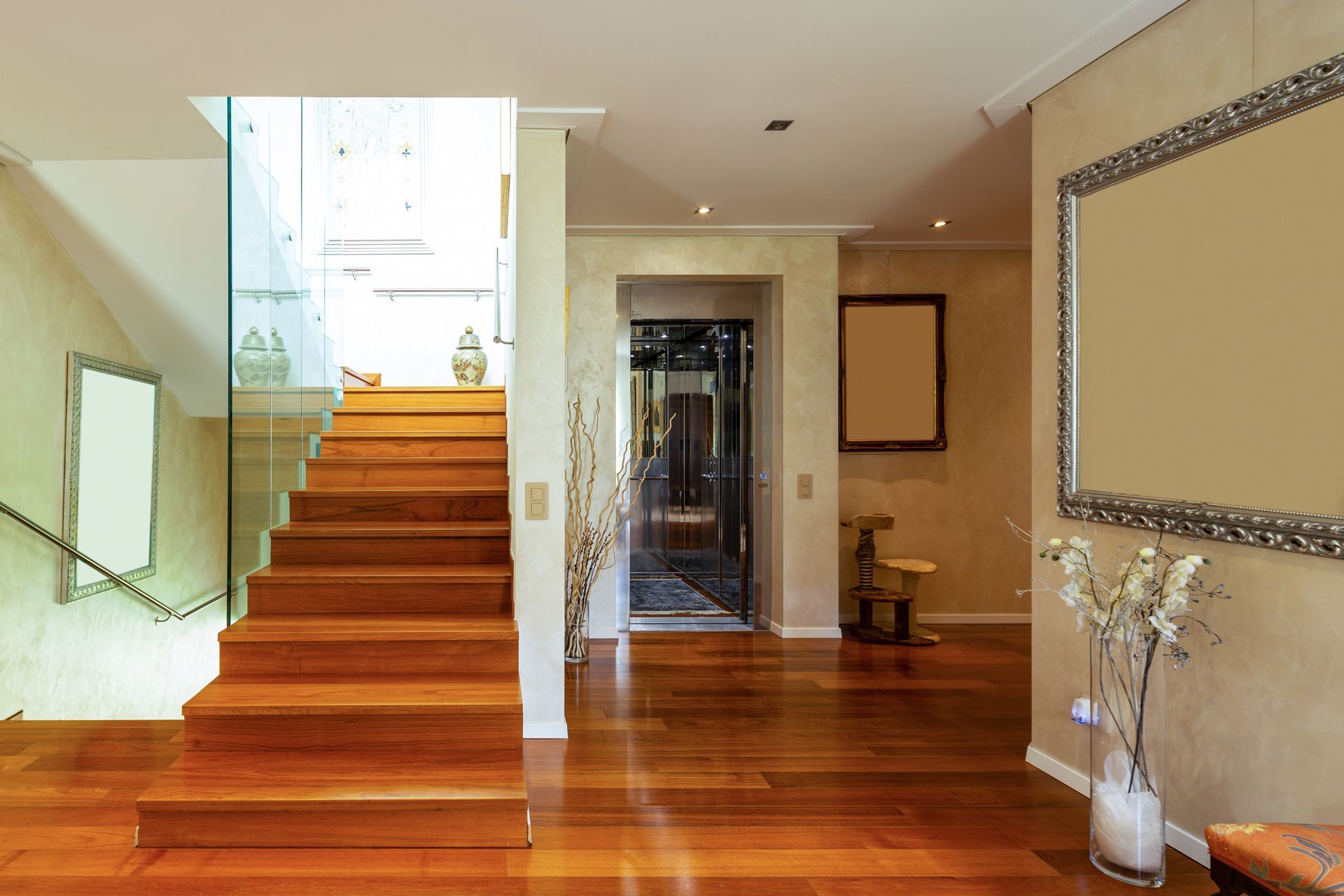 A Hallway With Wooden Floors and Stairs in a House