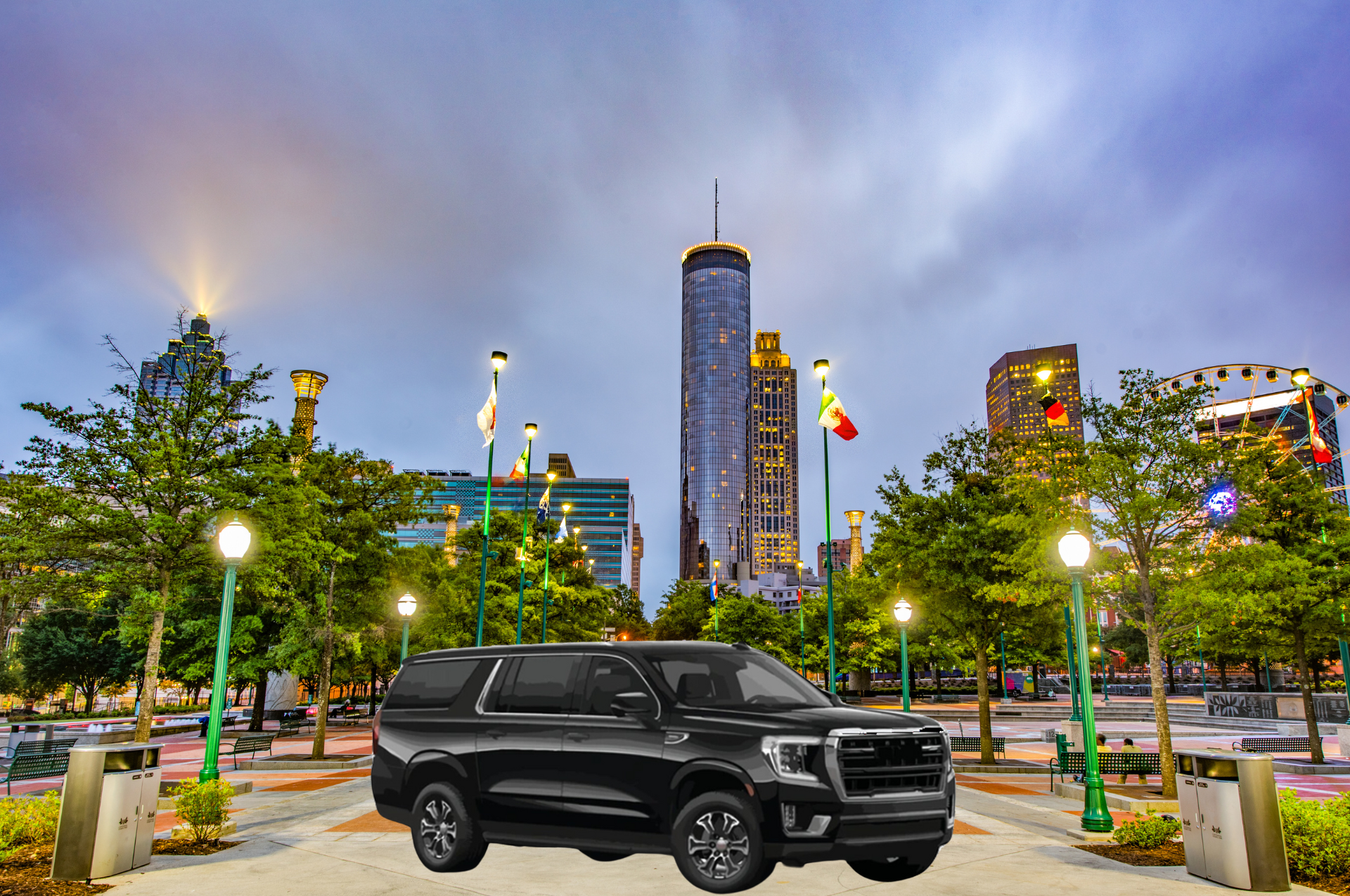 A black suv is parked in front of a city skyline.