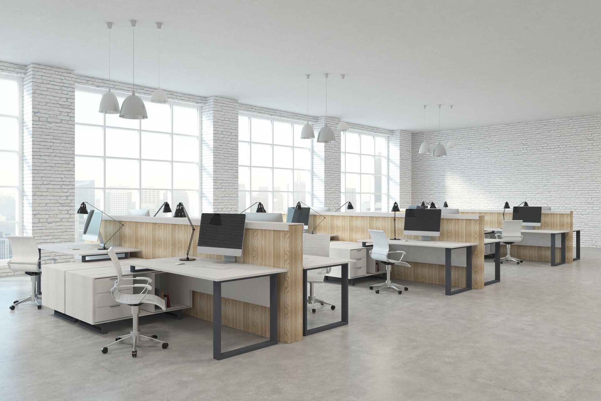 Open-plan office with wooden desk workstations, white chairs, computers and tall windows Open-plan office with wooden desk workstations, white chairs, computers and tall windows