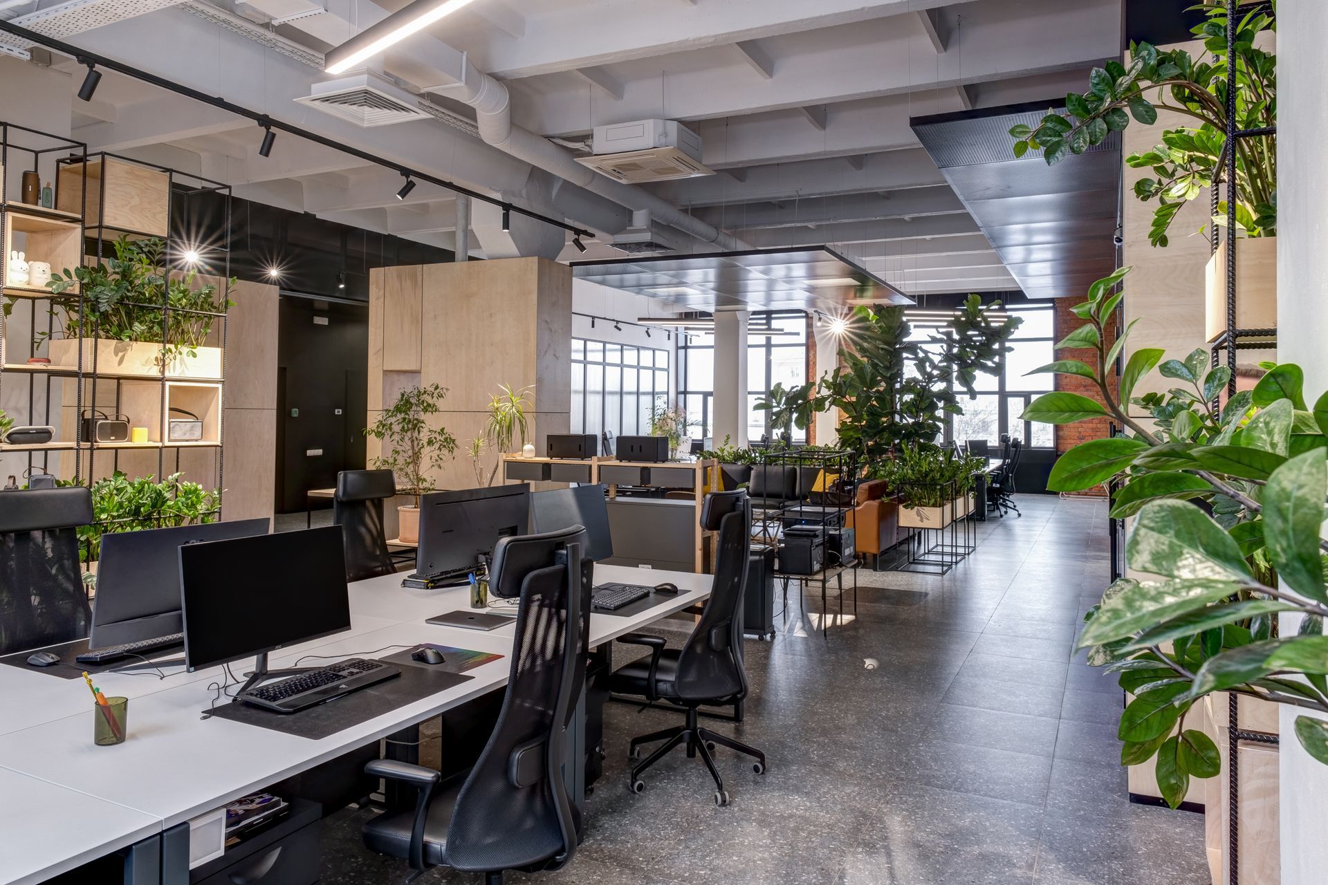 Modern loft-style office interior furnished with used office furniture Modern loft-style office interior furnished with used office furniture