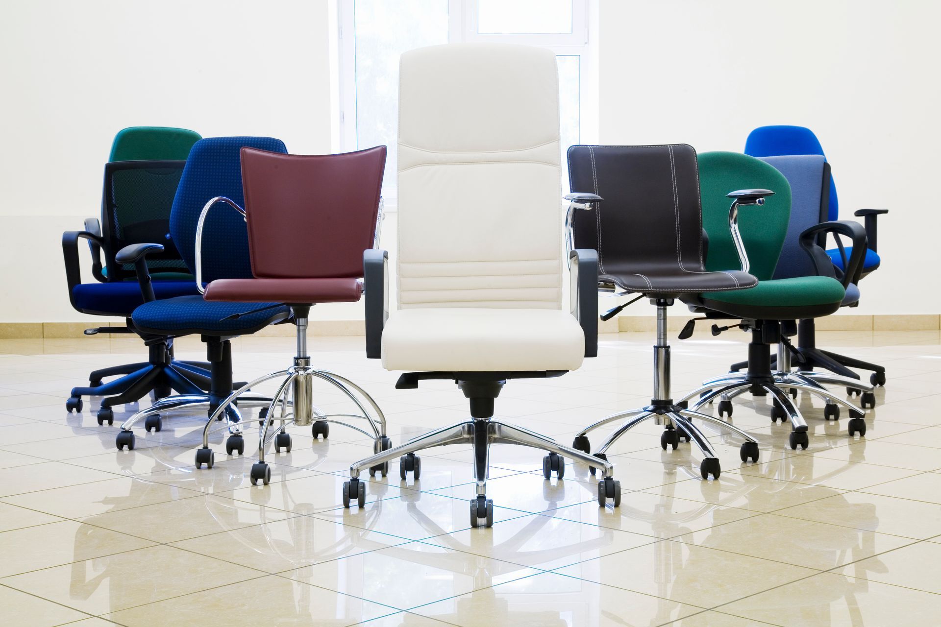 Assorted used ergonomic office chairs in various colors and styles.