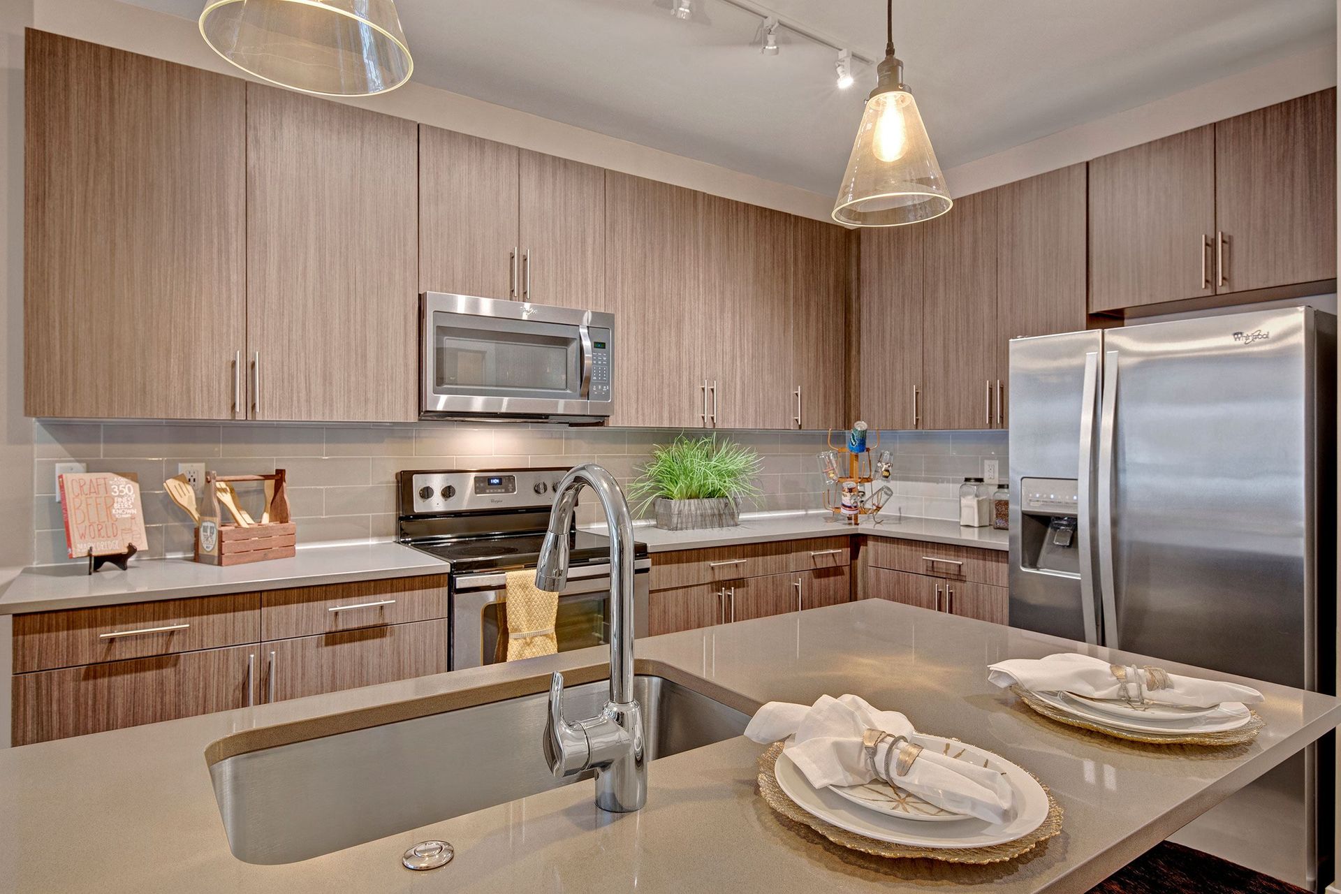 Modern kitchen with wood cabinets, stainless steel appliances, and a kitchen island.
