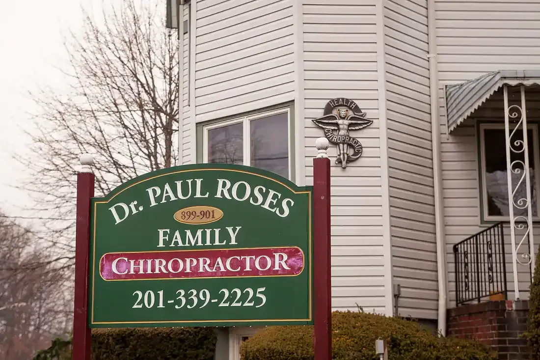 Sign for Dr. Paul Rose’s Family Chiropractic outside a house on a snowy day