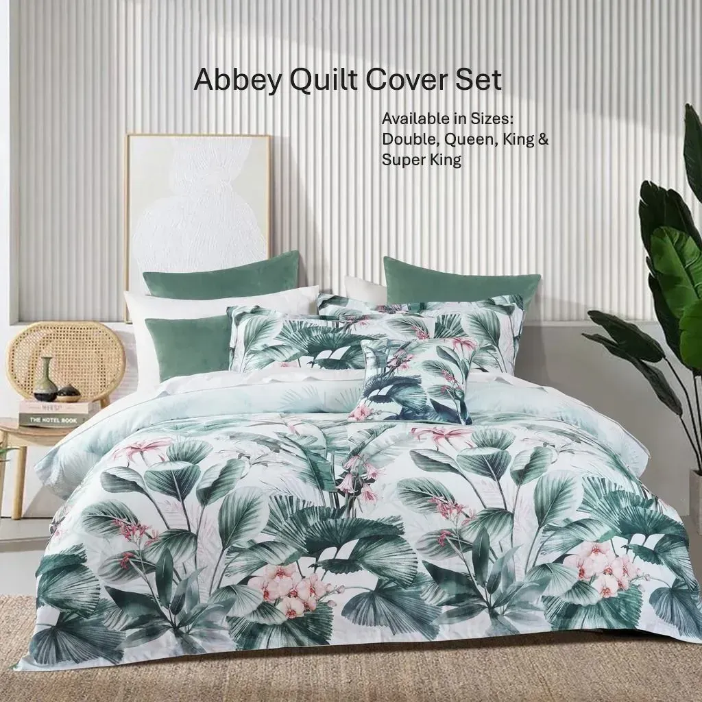 Floral quilt set on a bed with green pillows in a bright, modern bedroom