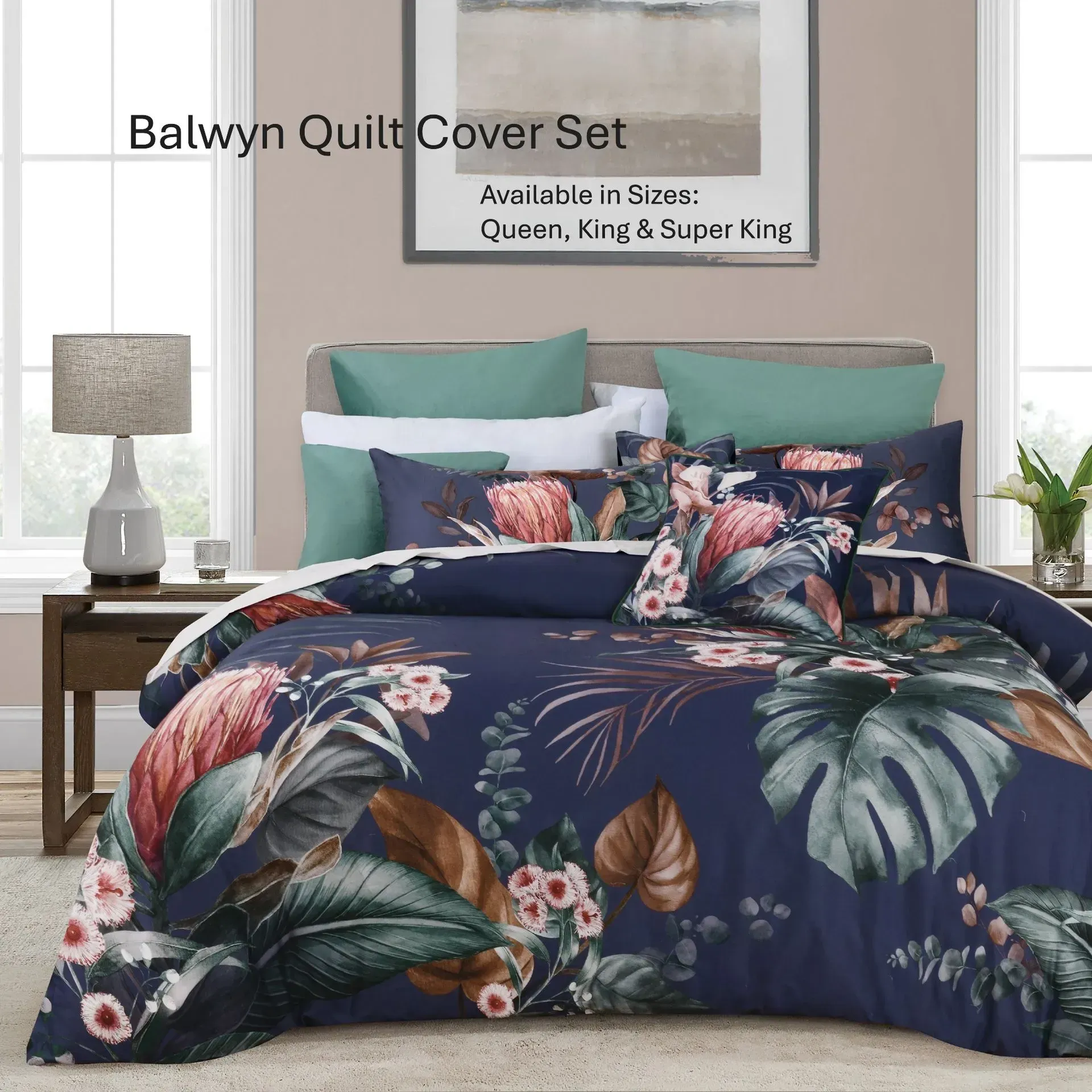 Floral navy quilt set on a bed with teal pillows in a bright bedroom