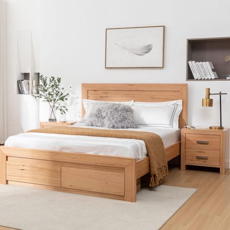 Modern bedroom with a wooden bed, white bedding, matching nightstands, and a light rug