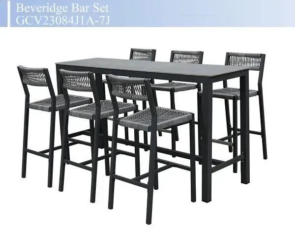Black wicker bar table set with four matching high stools on a white background