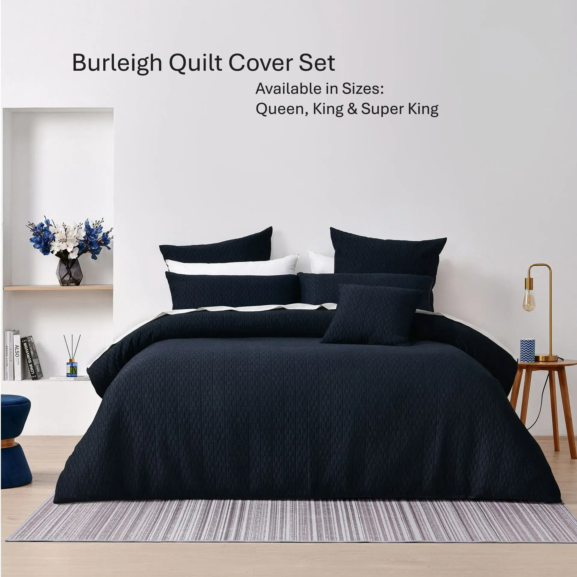 Burleigh quilt cover set on a bed in navy with striped pillowcases, shown in a modern bedroom