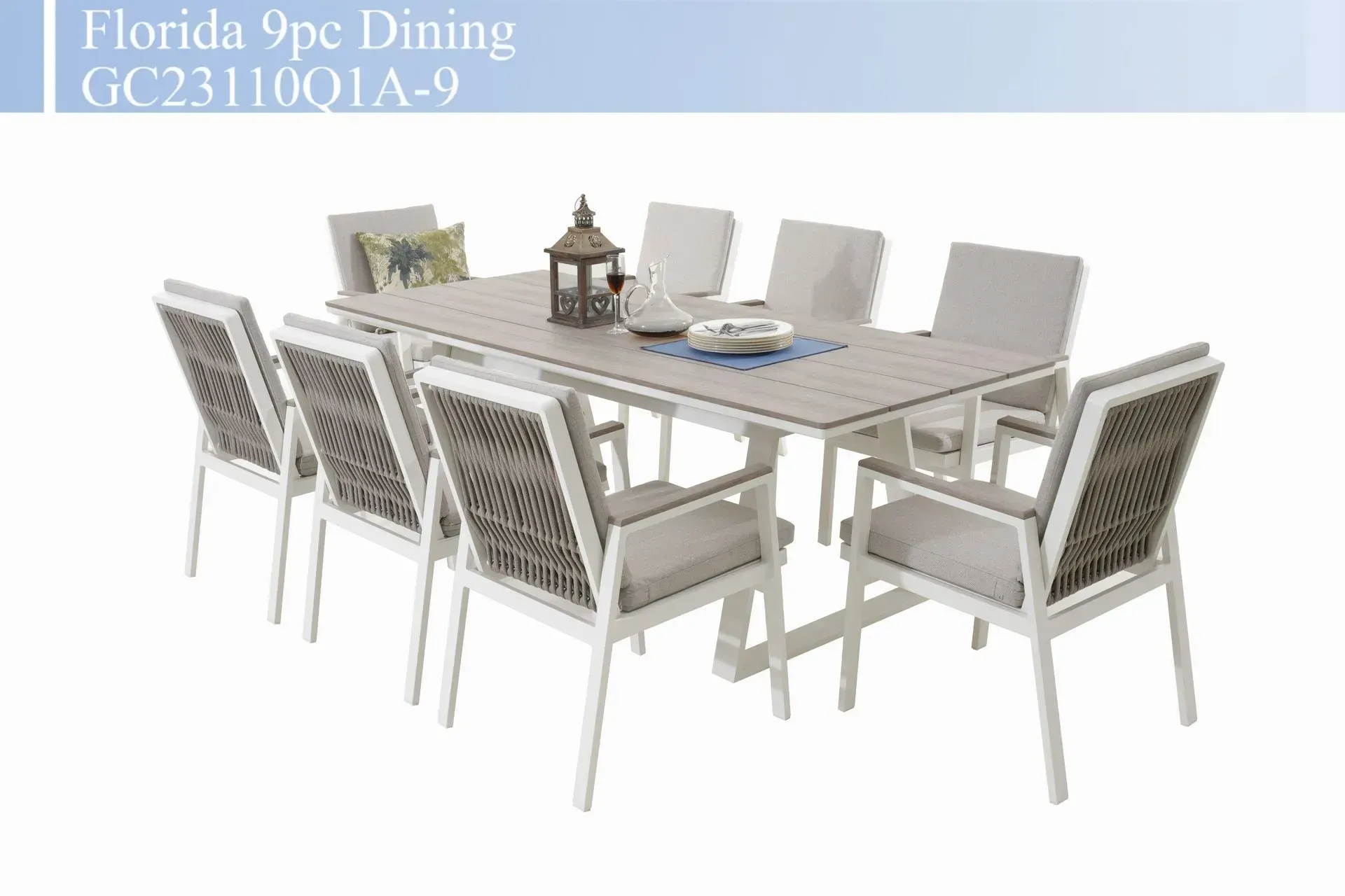 Gray dining set with rectangular table, six woven chairs, and tableware on a white background