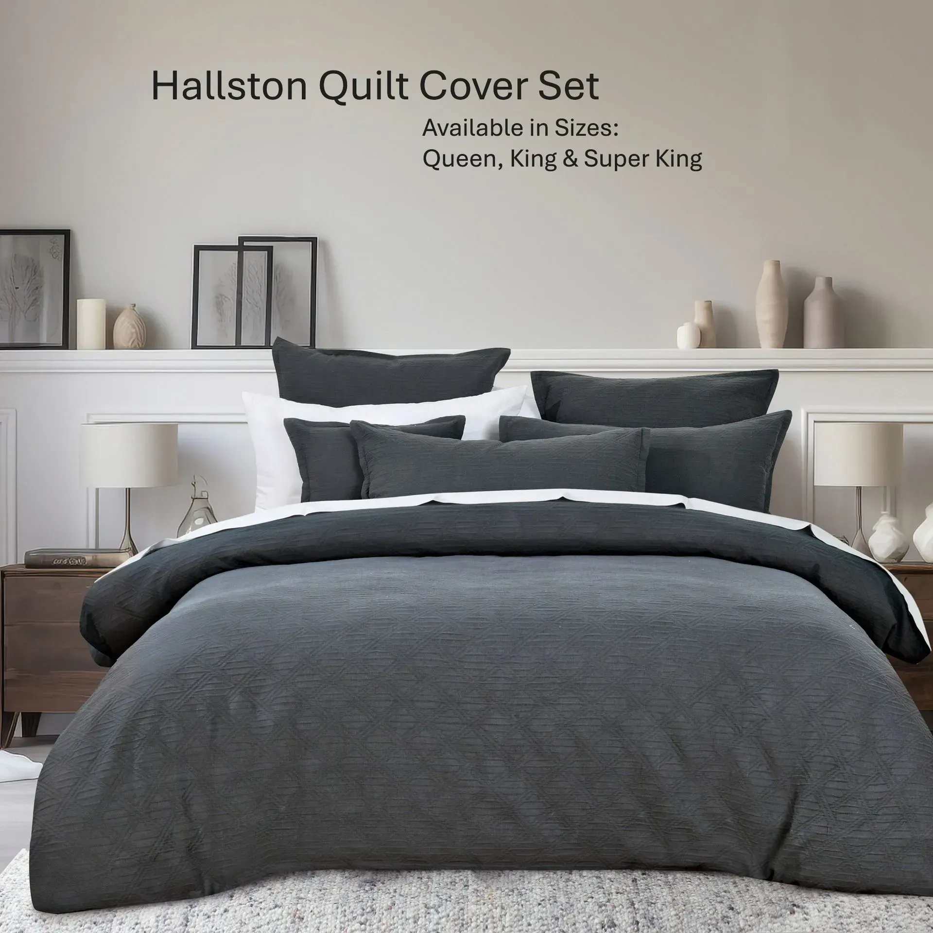 Dark gray quilt cover set on a neatly made bed in a modern bedroom with white walls and lamps.