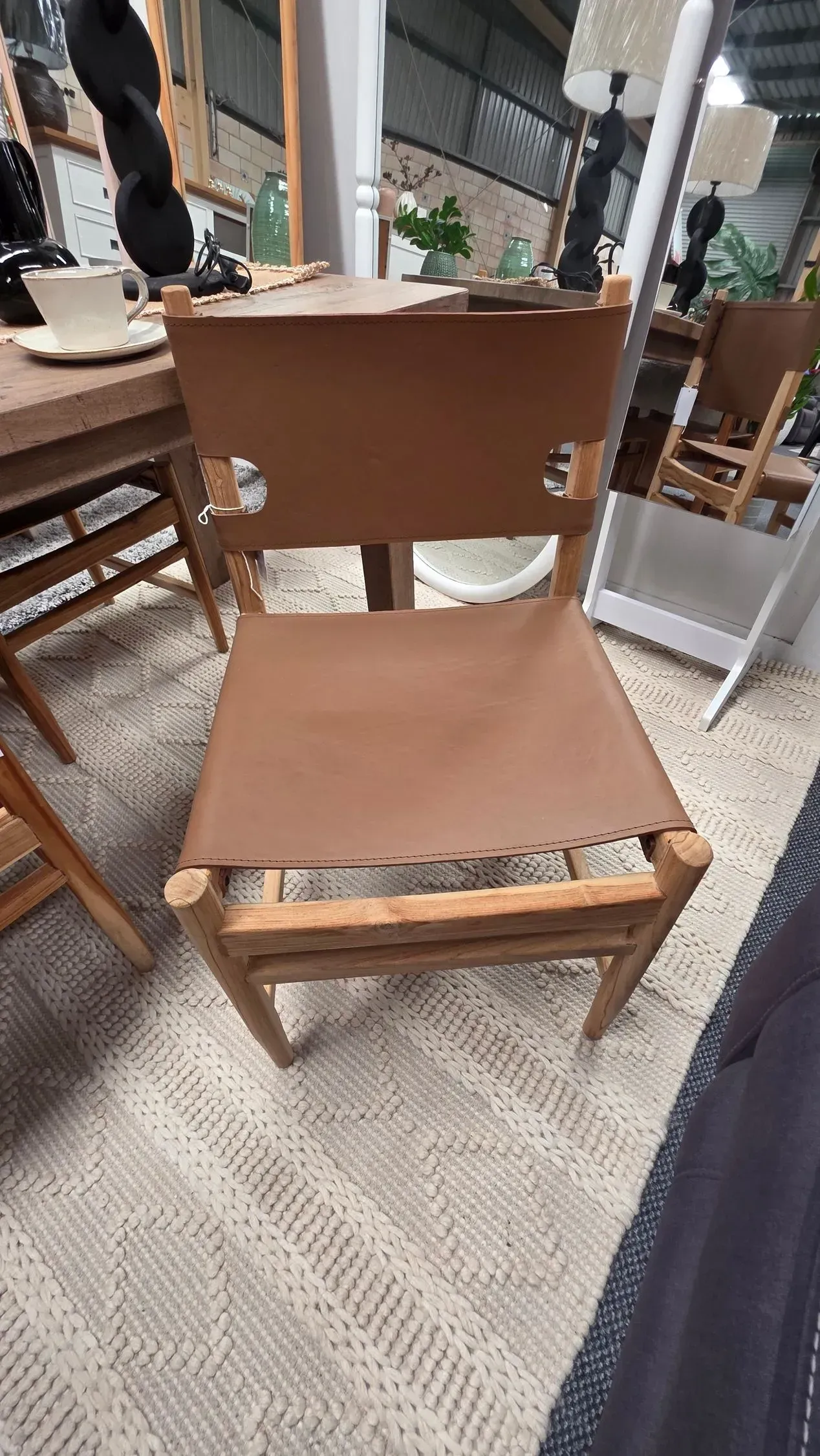 Wooden chair with a brown seat and backrest in a café or patio setting