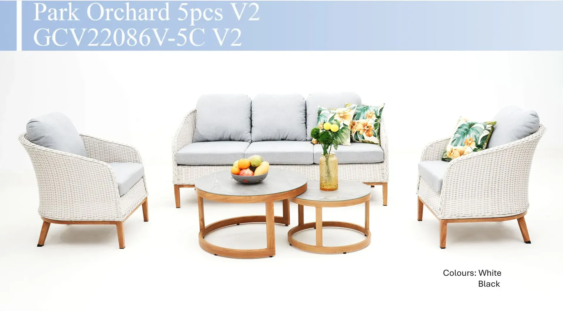 White wicker outdoor sofa set with floral cushions, round wooden tables, and matching armchairs on a white background