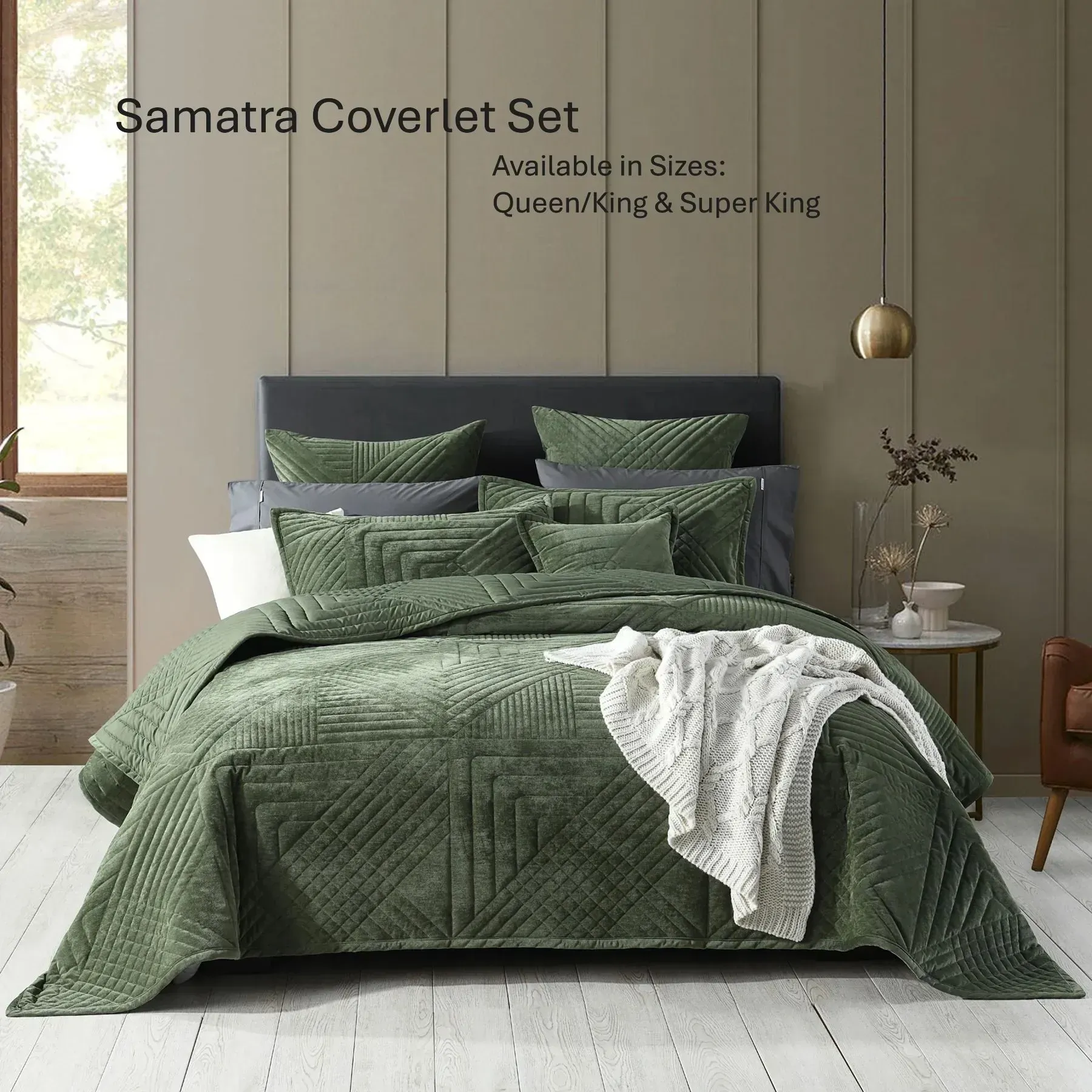Green quilted coverlet set on a bed in a bright bedroom, with pillow shams and a white throw blanket.