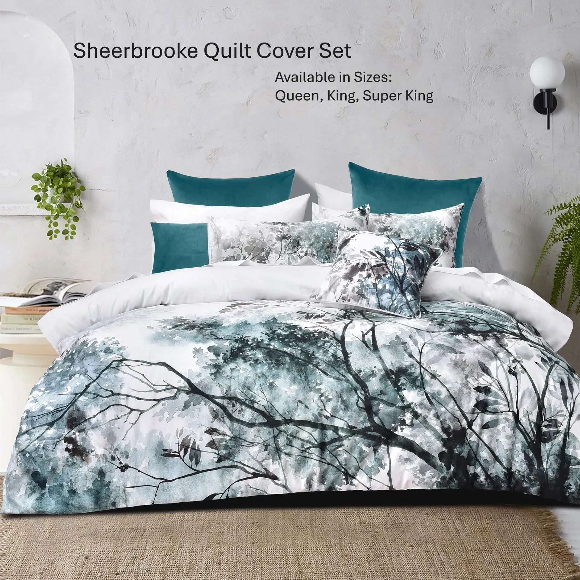 Teal and white quilt cover set on a bed with tree branch print, shown in a bedroom setting