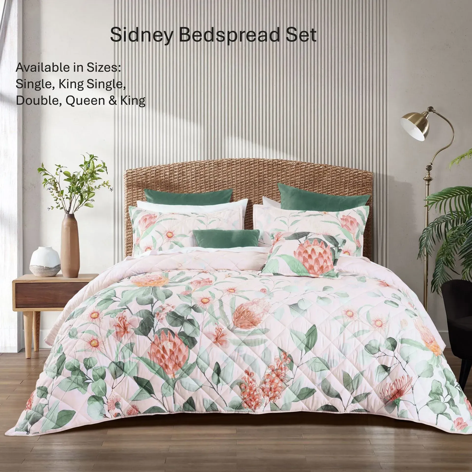 Floral pink and green bedspread set on a bed in a modern bedroom with wood nightstands and lamps