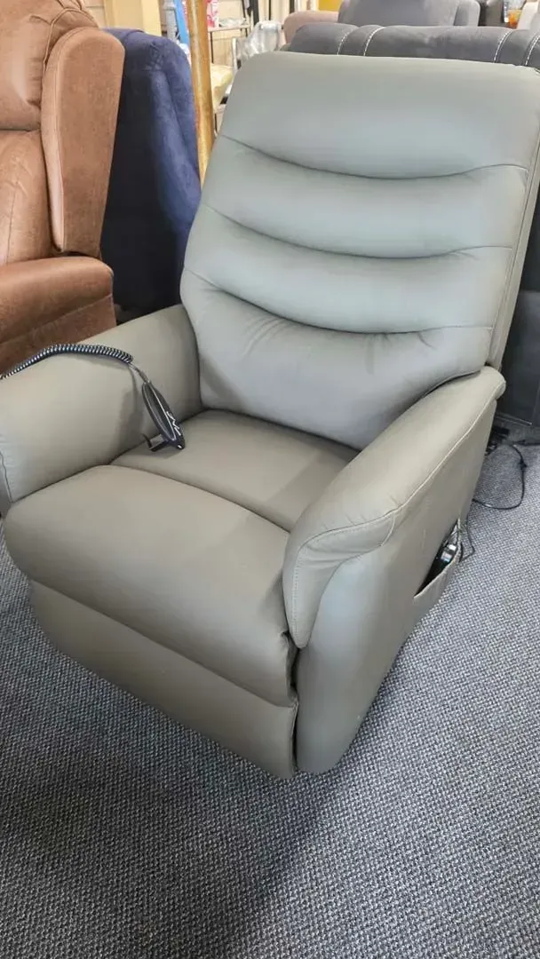 Light gray recliner chair on a showroom carpet beside a brown chair