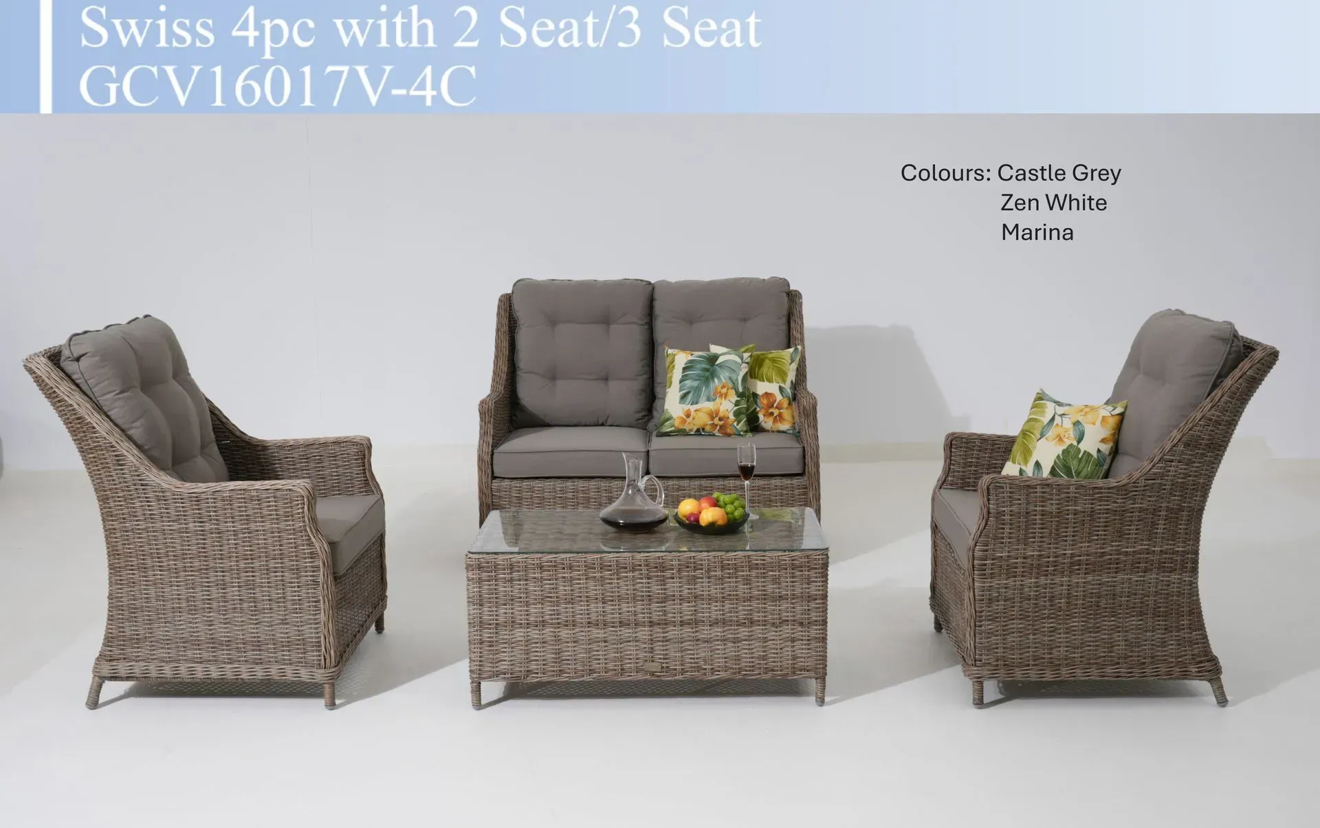 Wicker patio furniture set with loveseat, two chairs, and coffee table with cushions and decorative pillows
