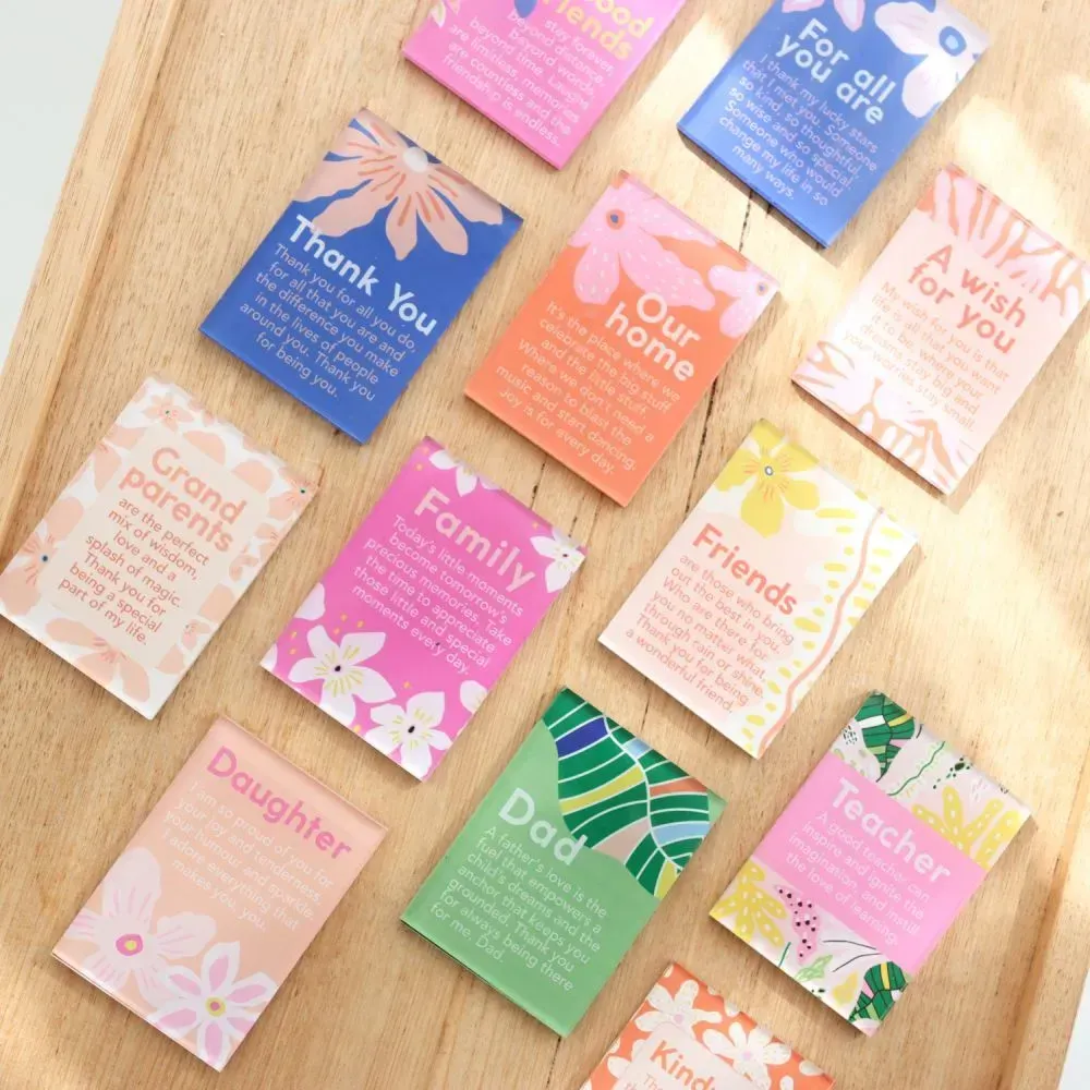 Assorted colorful greeting cards arranged on a wooden surface