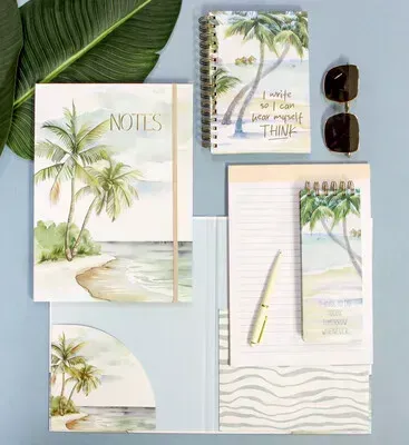 Tropical palm tree stationery set with notebooks, notepad, pen, and sunglasses on a light blue background