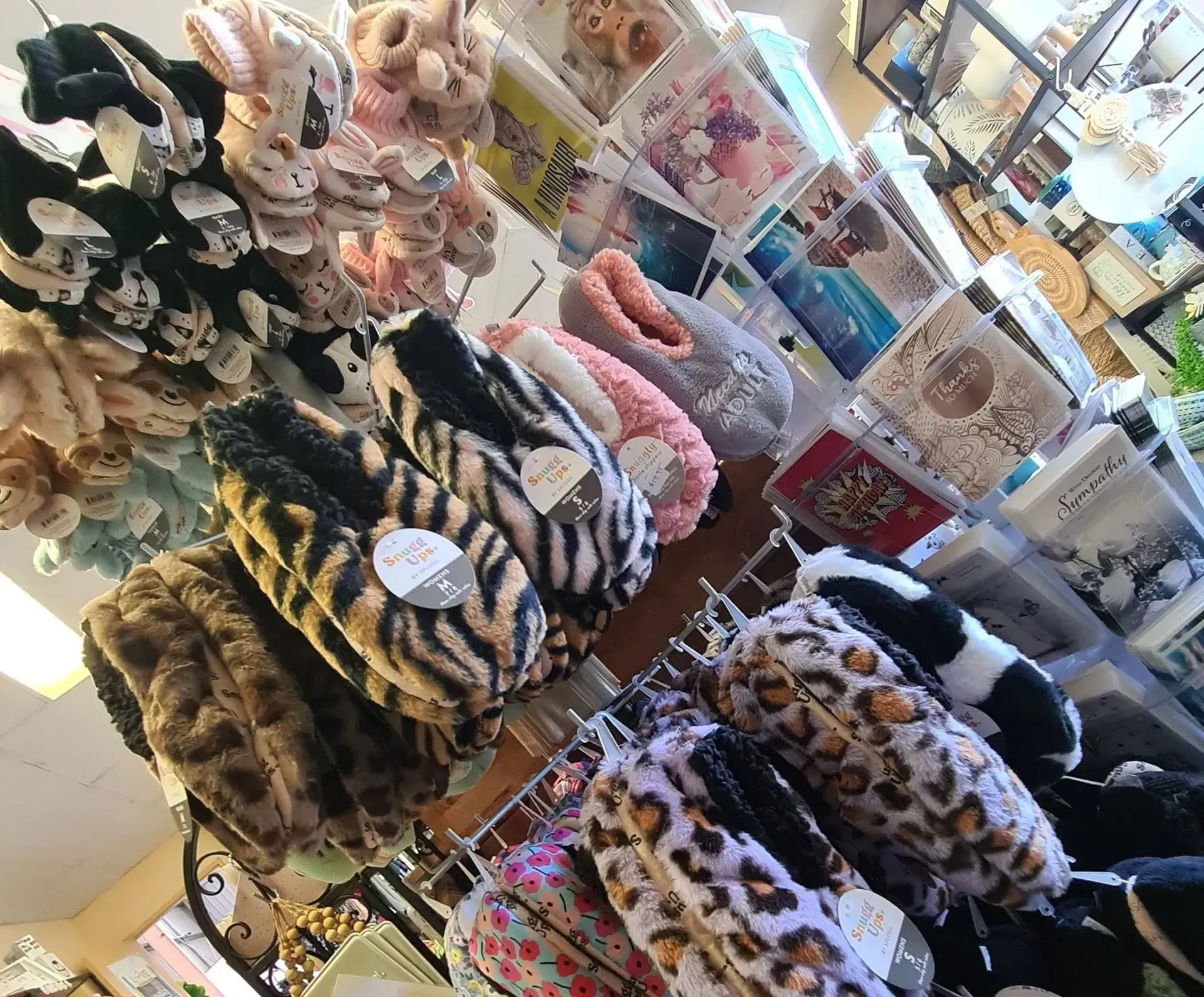 Display of assorted plush toys and patterned accessories on store shelves