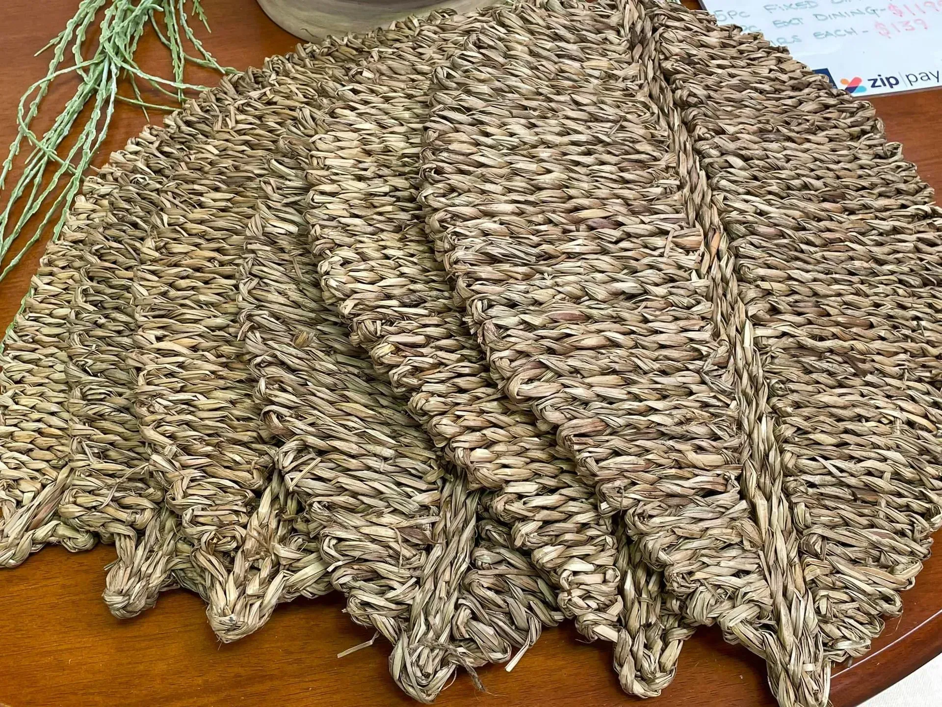 Two textured knit scarves or blankets in tan and brown, folded on a wooden surface