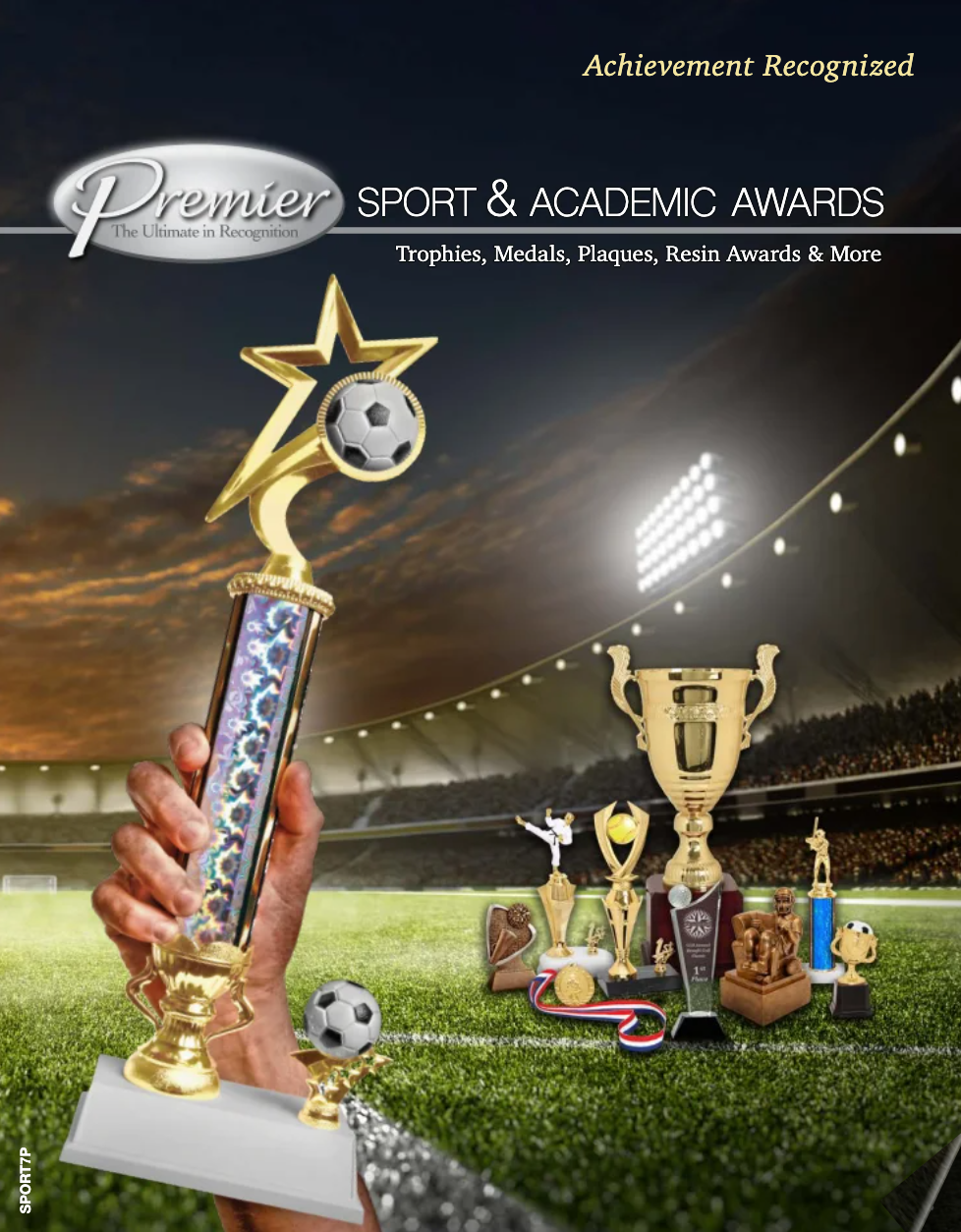 A person is holding a trophy in front of a soccer field.
