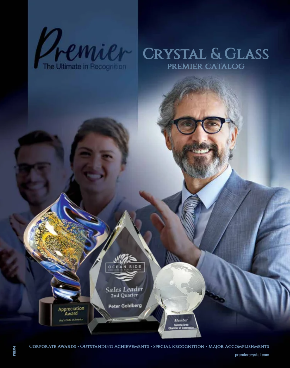 A man in a suit and tie is holding a trophy.