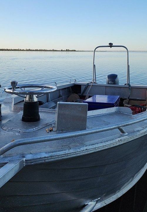 a boat is docked in the water at sunset