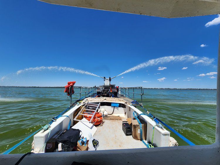 a boat is spraying water into the water