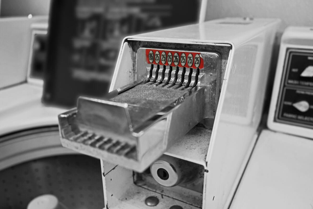 Close-up of a coin tray on machine at laundromat