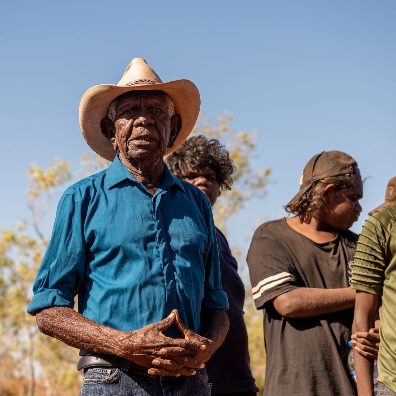 A man wearing a cowboy hat and a blue shirt