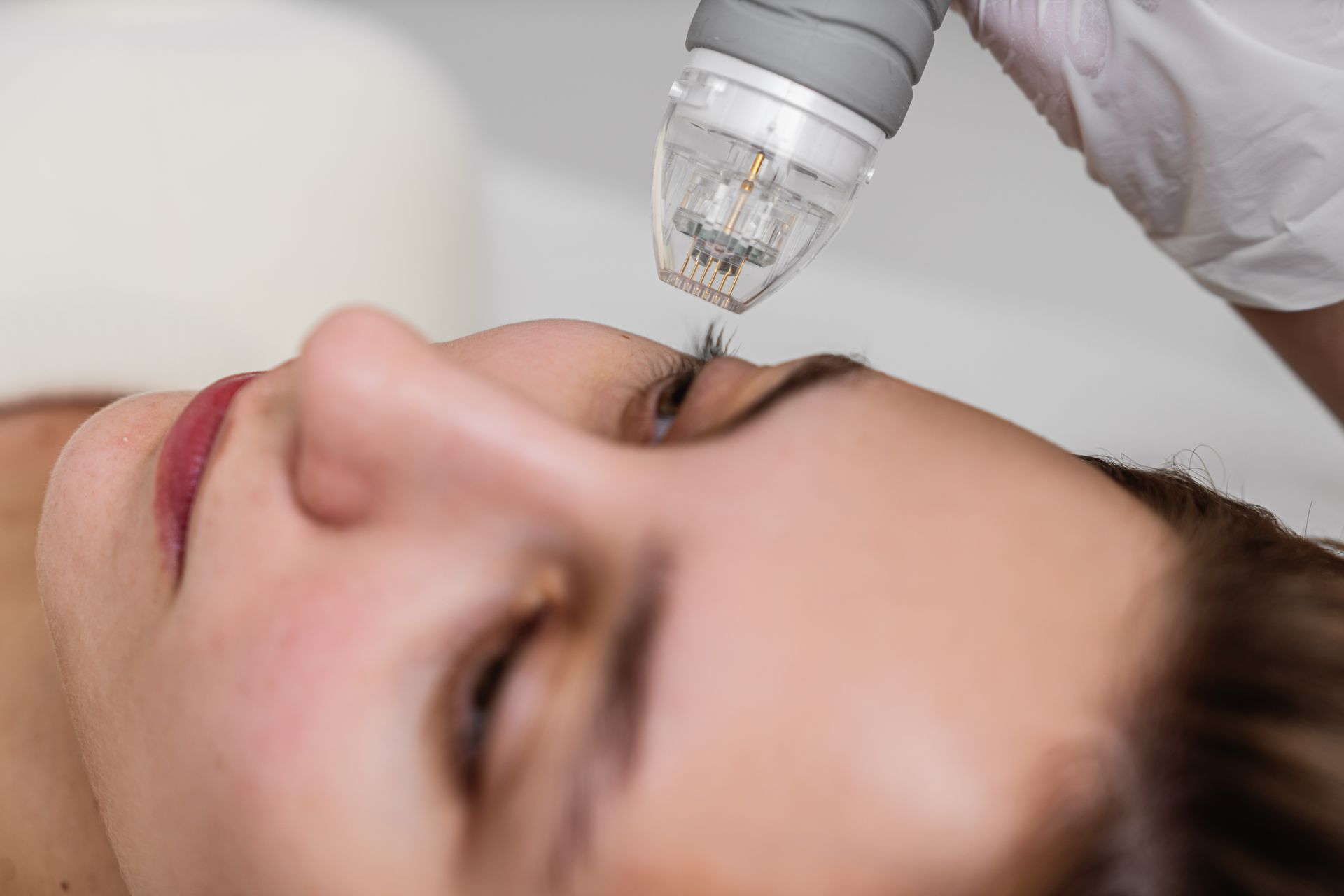 A woman is getting a facial treatment at a beauty salon.