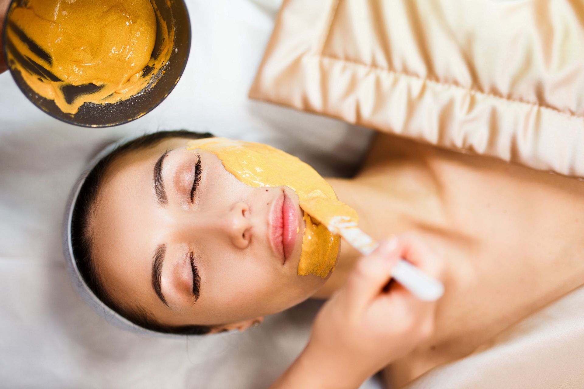 A woman is getting a facial treatment at a spa.