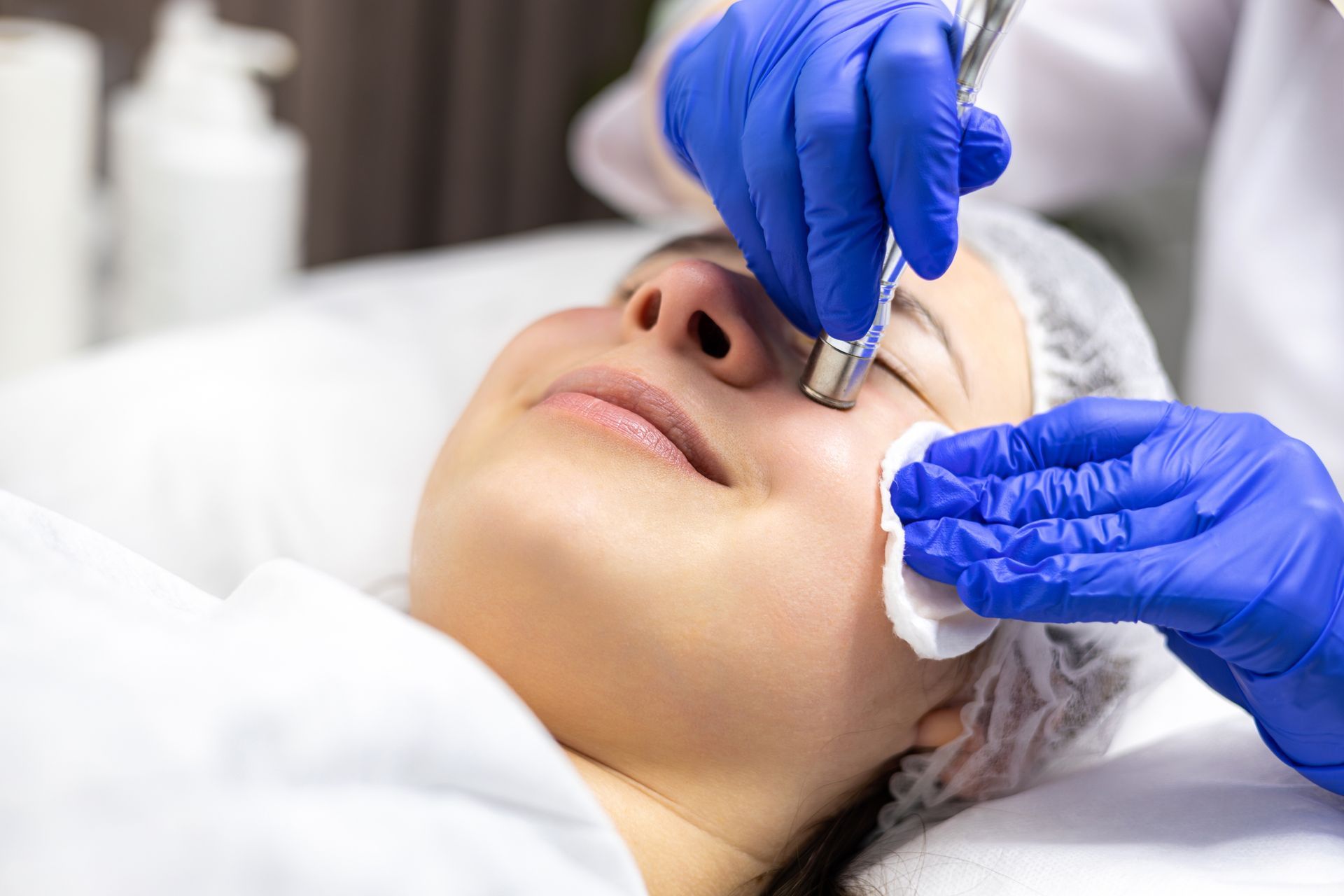 A woman is getting a facial treatment at a beauty salon.