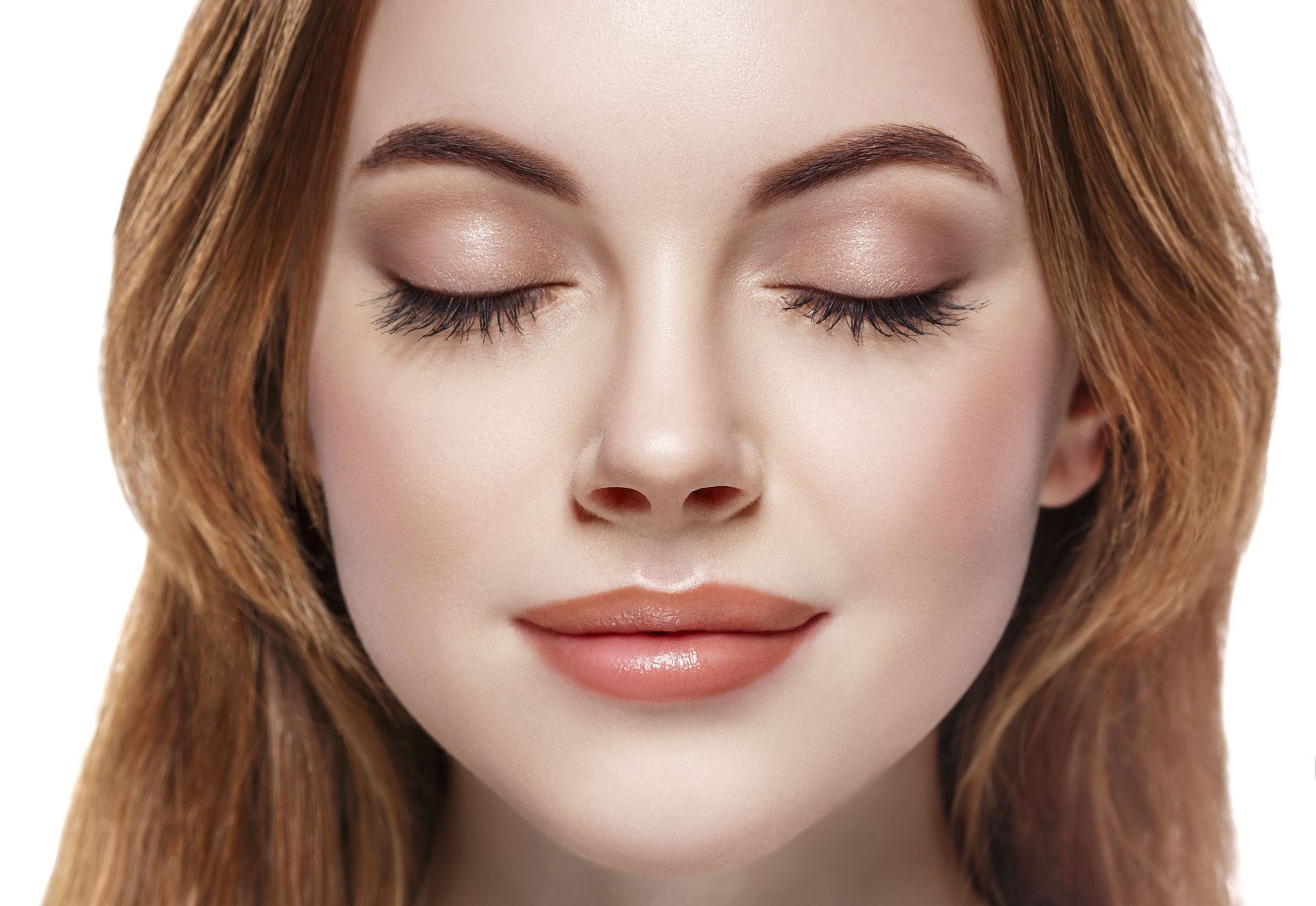 A close up of a woman 's face with her eyes closed.
