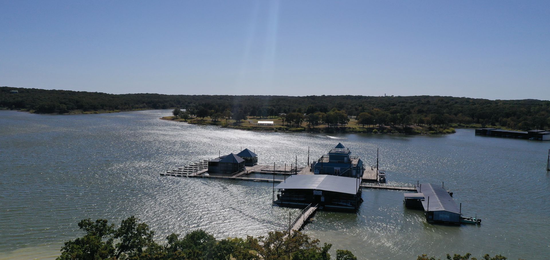 A large body of water surrounded by trees and buildings
