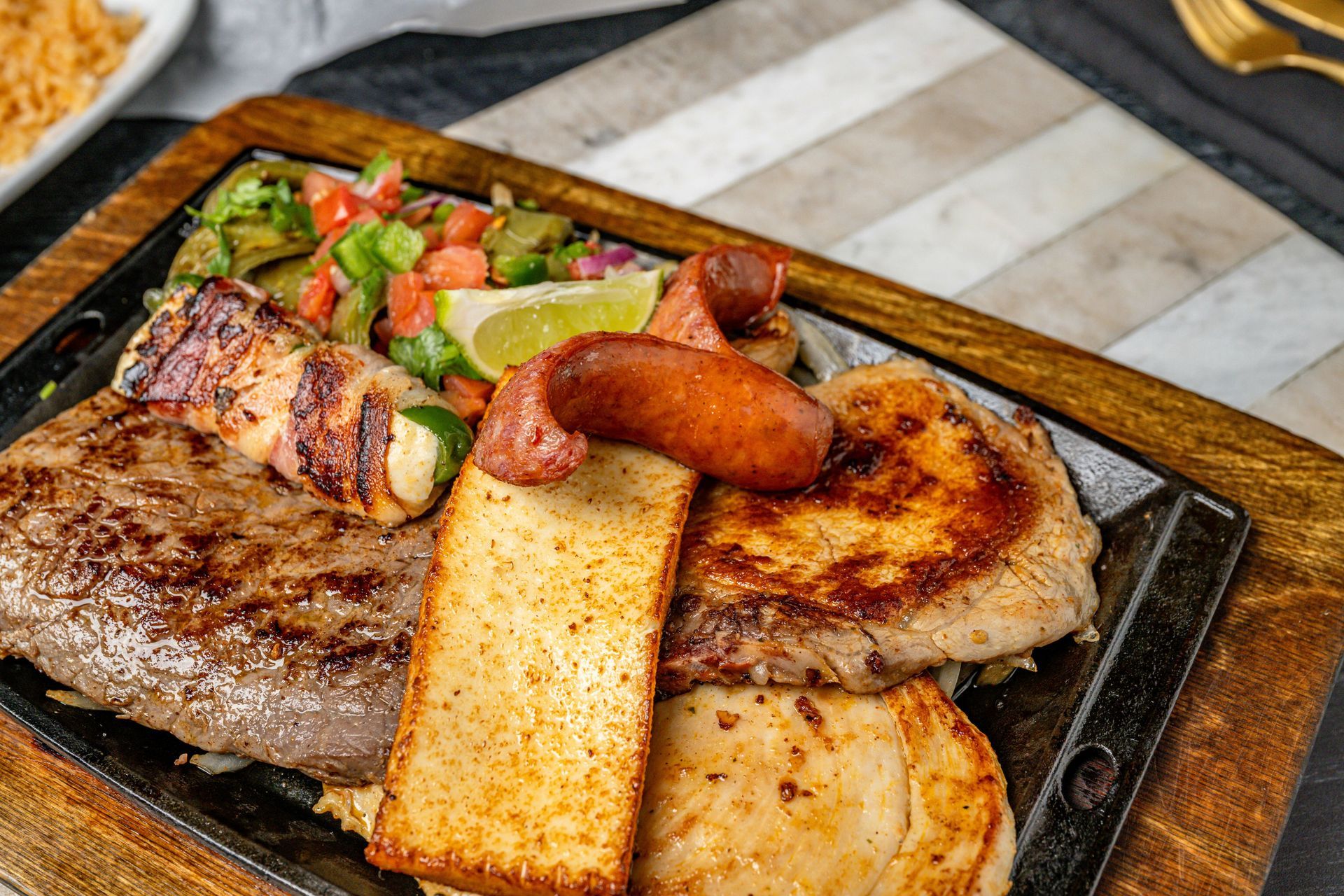 A close up of a plate of food on a wooden table.