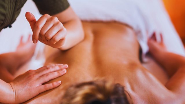 Massage therapist performing deep tissue massage at casey healing wellness