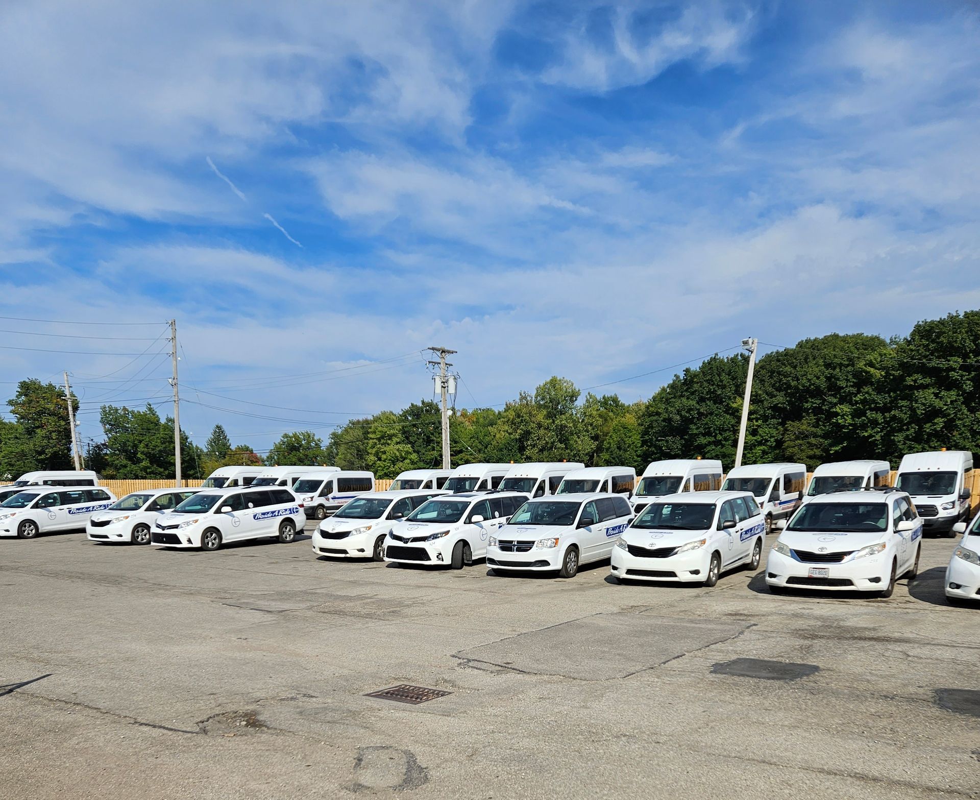 A Row of White Vans Parked in Front of A Building - Parma, OH - Family First Car Care