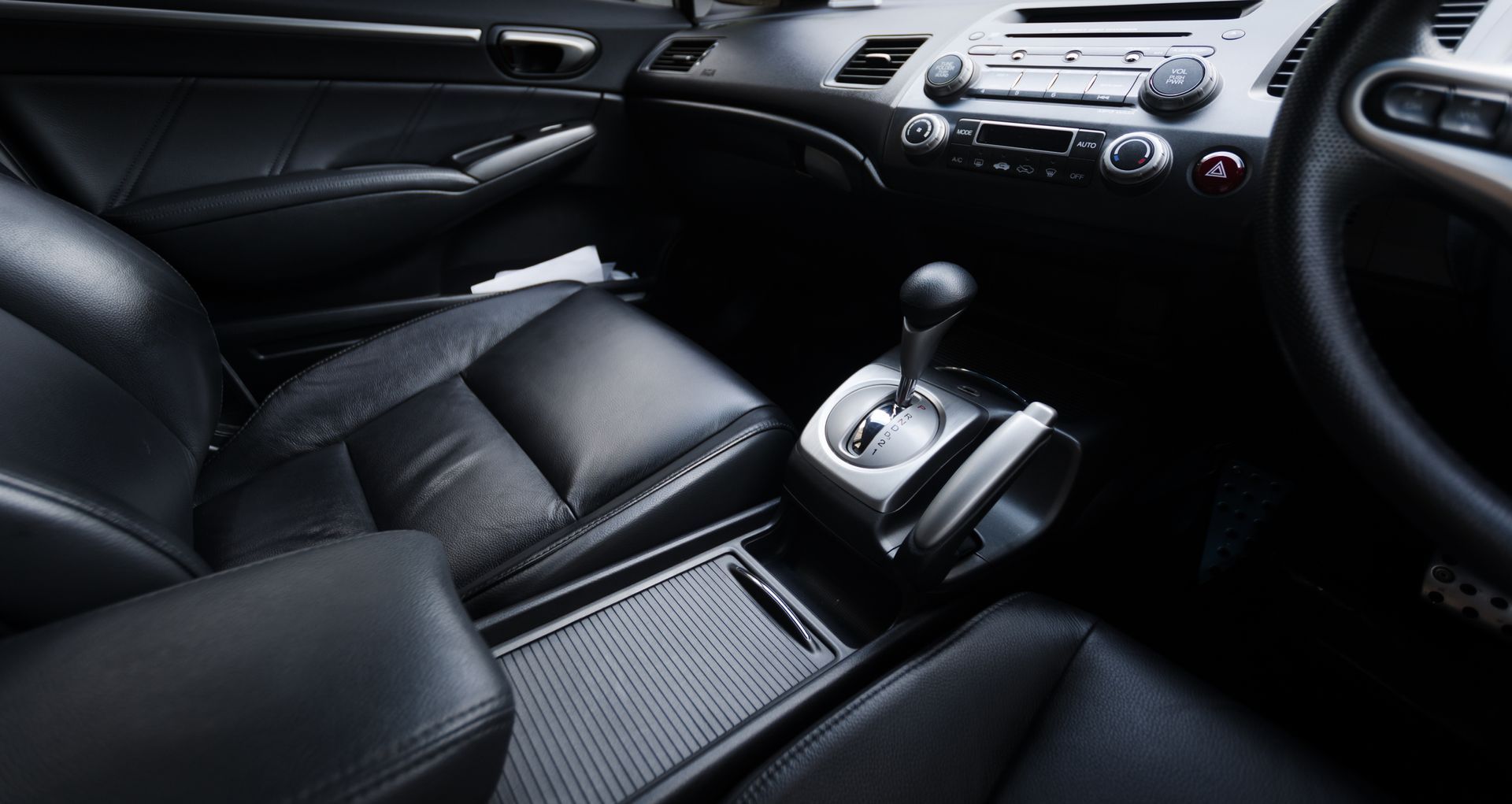 The Interior of A Car with Black Leather Seats and A Steering Wheel - Parma, OH - Family First Car Care