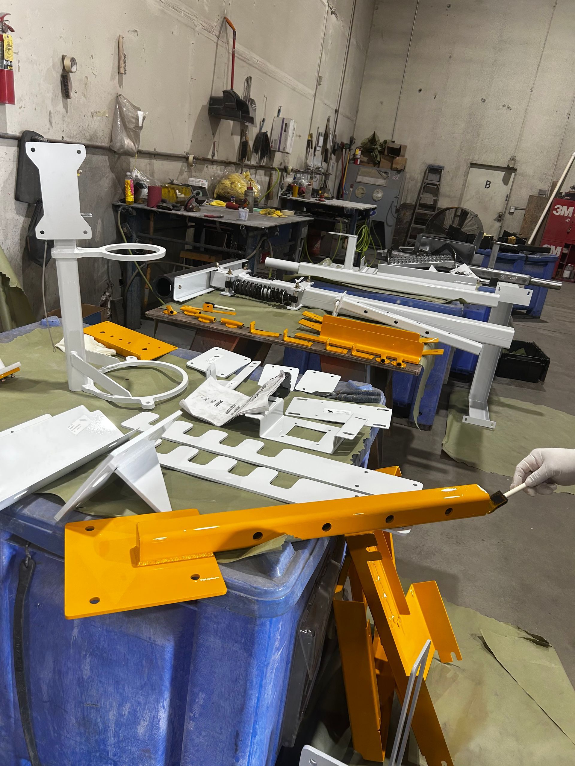 A batch of industrial parts moving through prep for refinishing.
