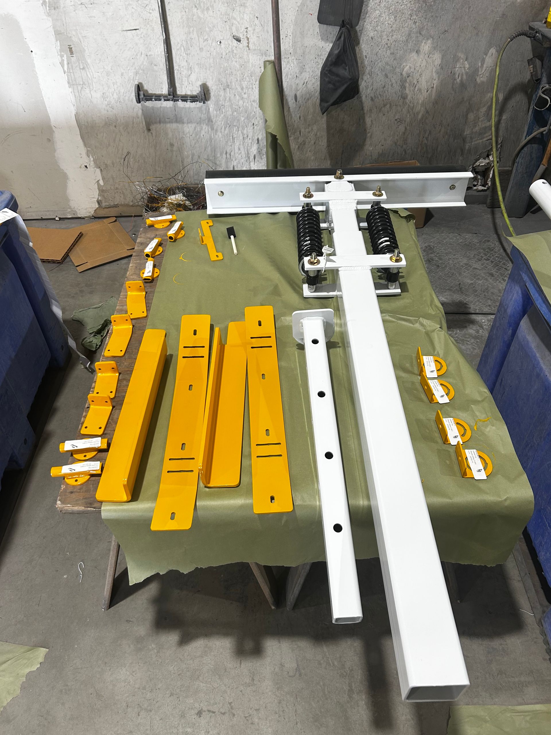 Disassembled manufactured parts staged for prep and refinishing in BCN's Woodland paint shop.