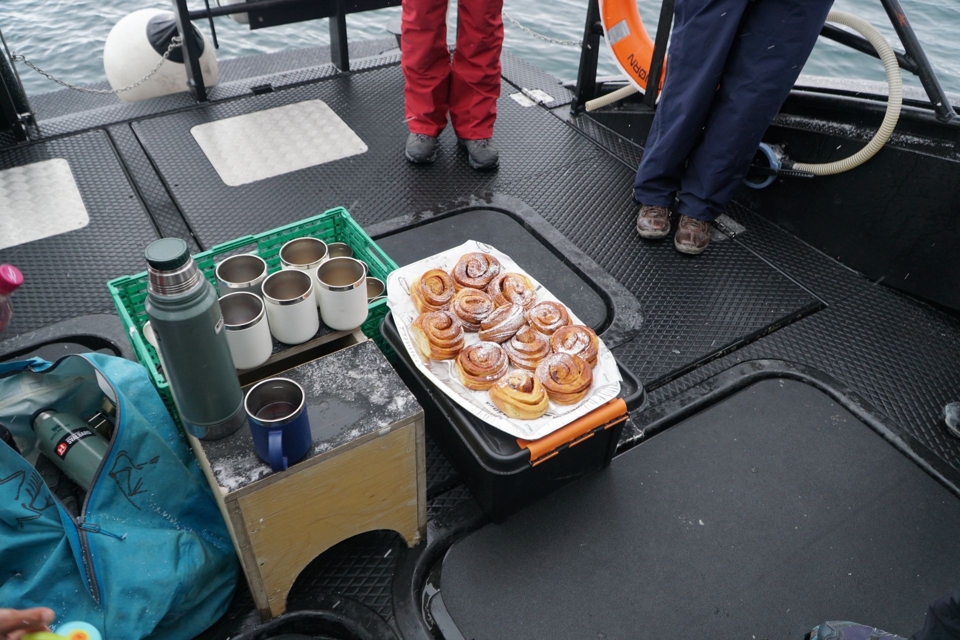 A tray of cinnamon rolls sits on a table on a boat.
