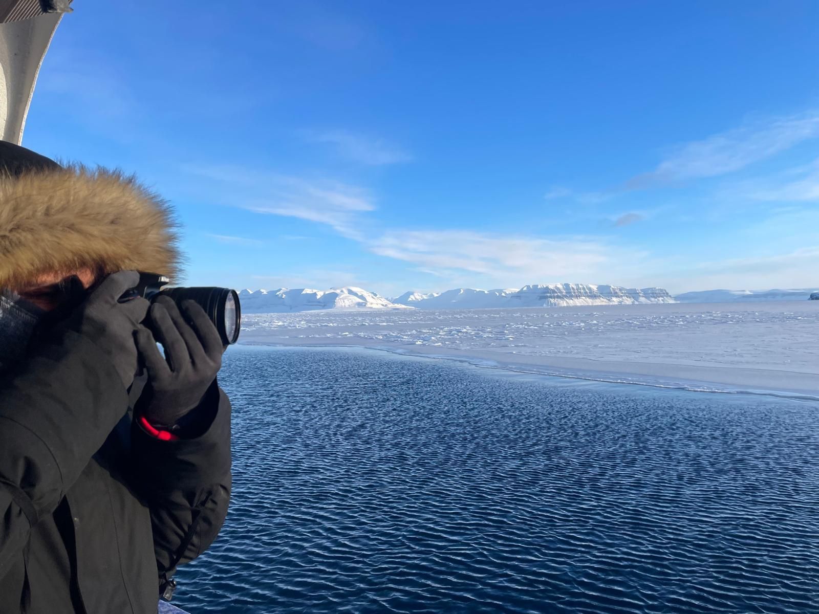 A person is taking a picture of a body of water